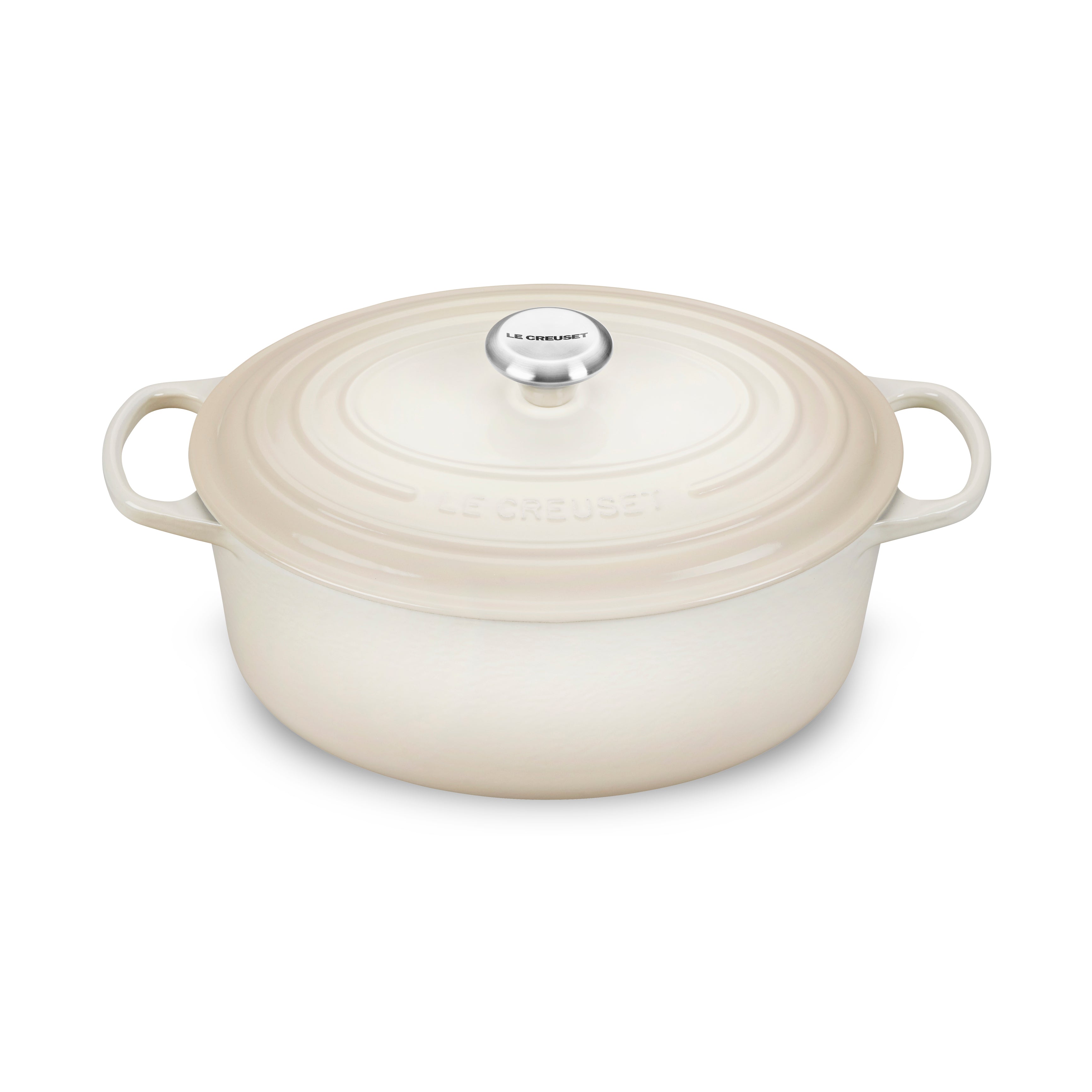Le Creuset enameled Dutch oven in Meringue finish showcasing the ergonomic handle and lid