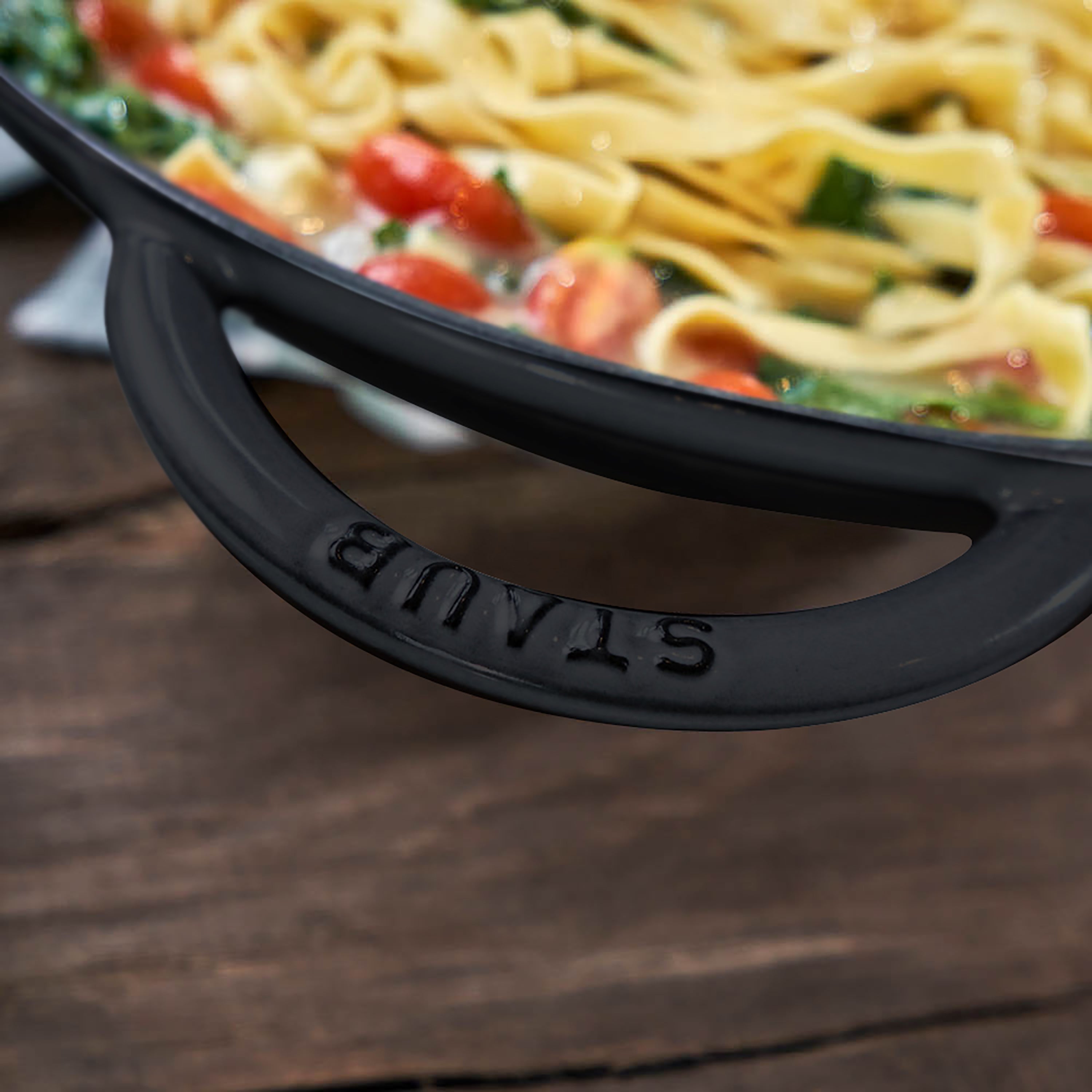 Stainless steel rack and glass lid included with the Staub enameled wok, ideal for steaming and moisture retention