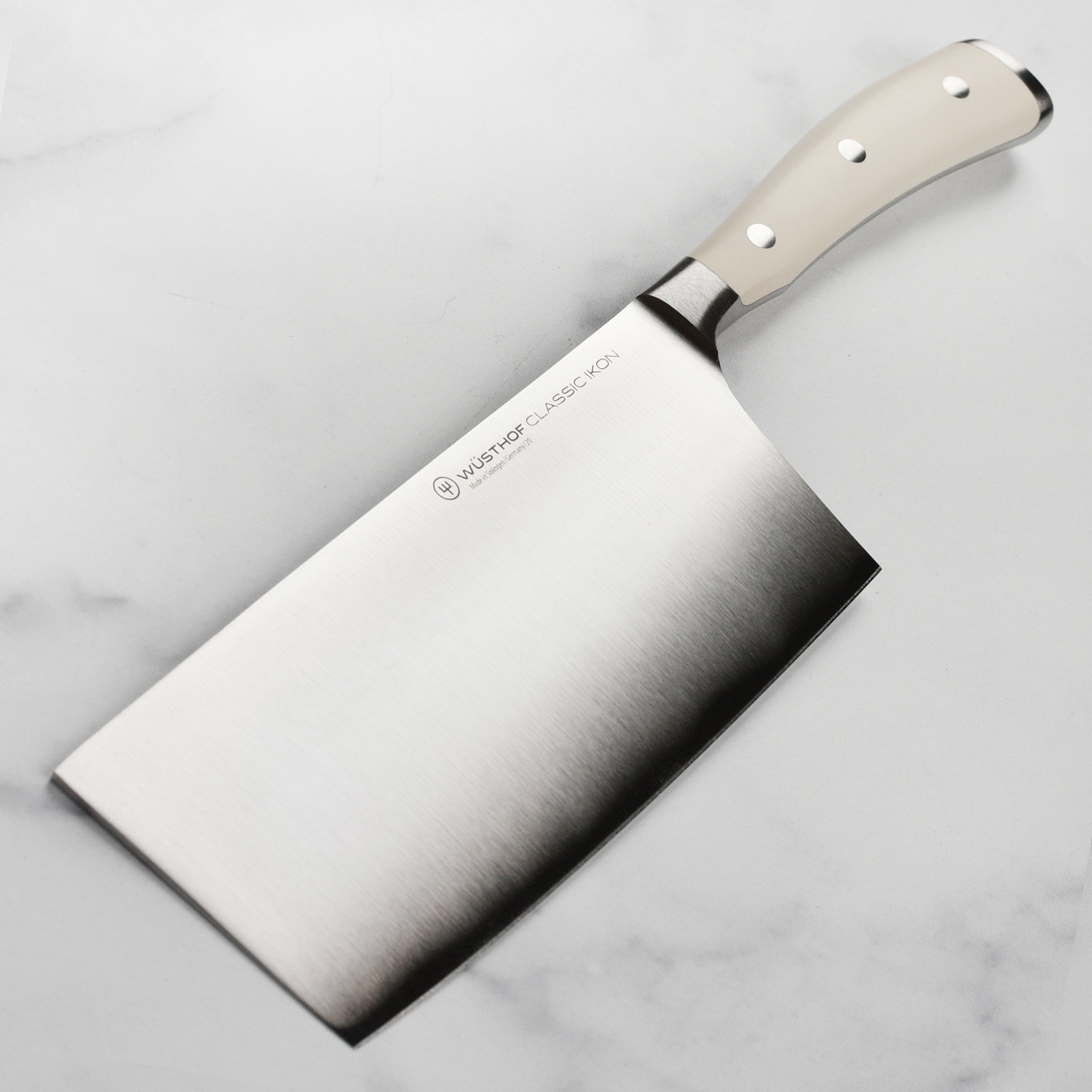 Wusthof Classic Ikon Creme 7-inch Chinese chef's knife showcasing its sharp blade and premium craftsmanship