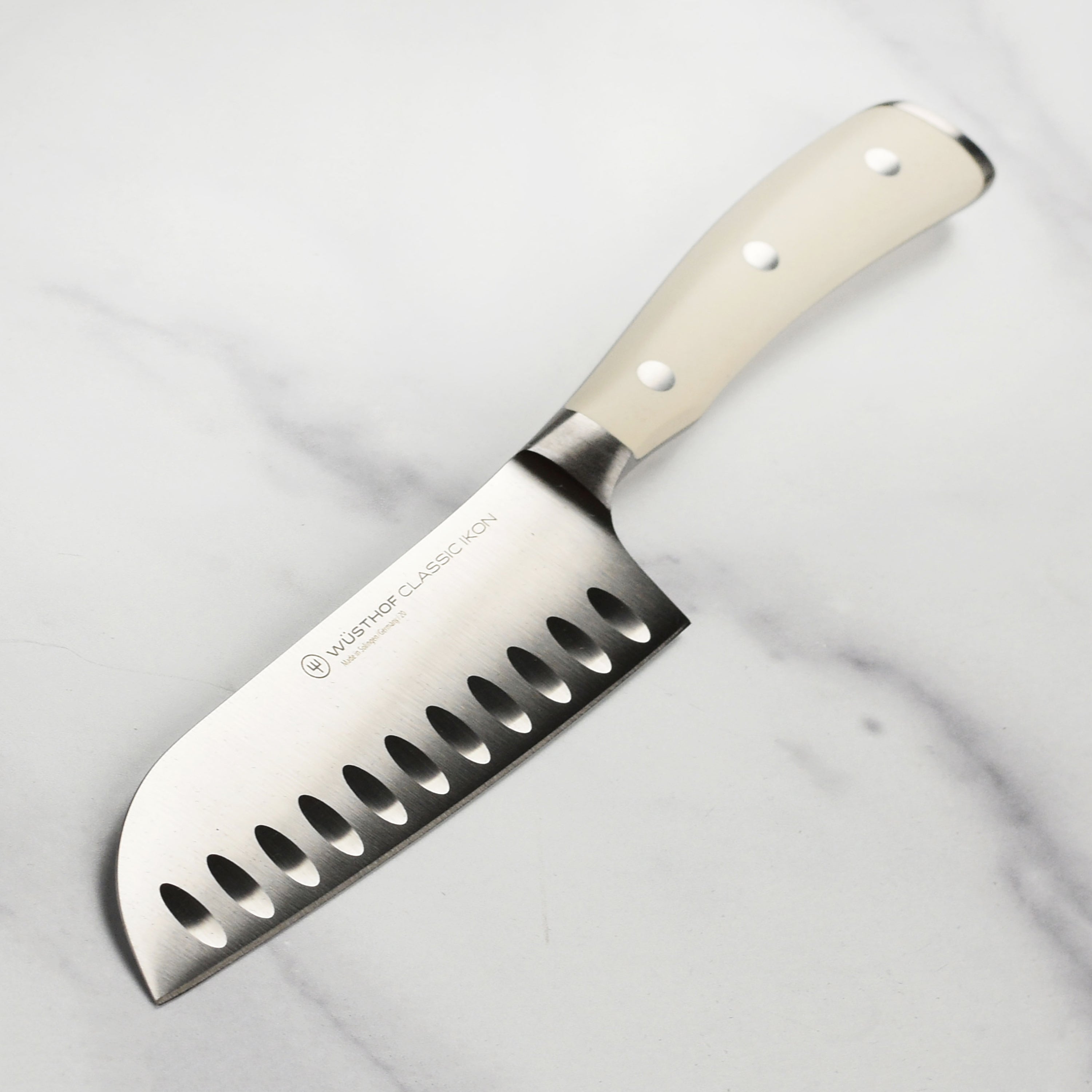 Close-up of Wusthof Santoku knife blade showing hollow edge and ultra-sharp finish