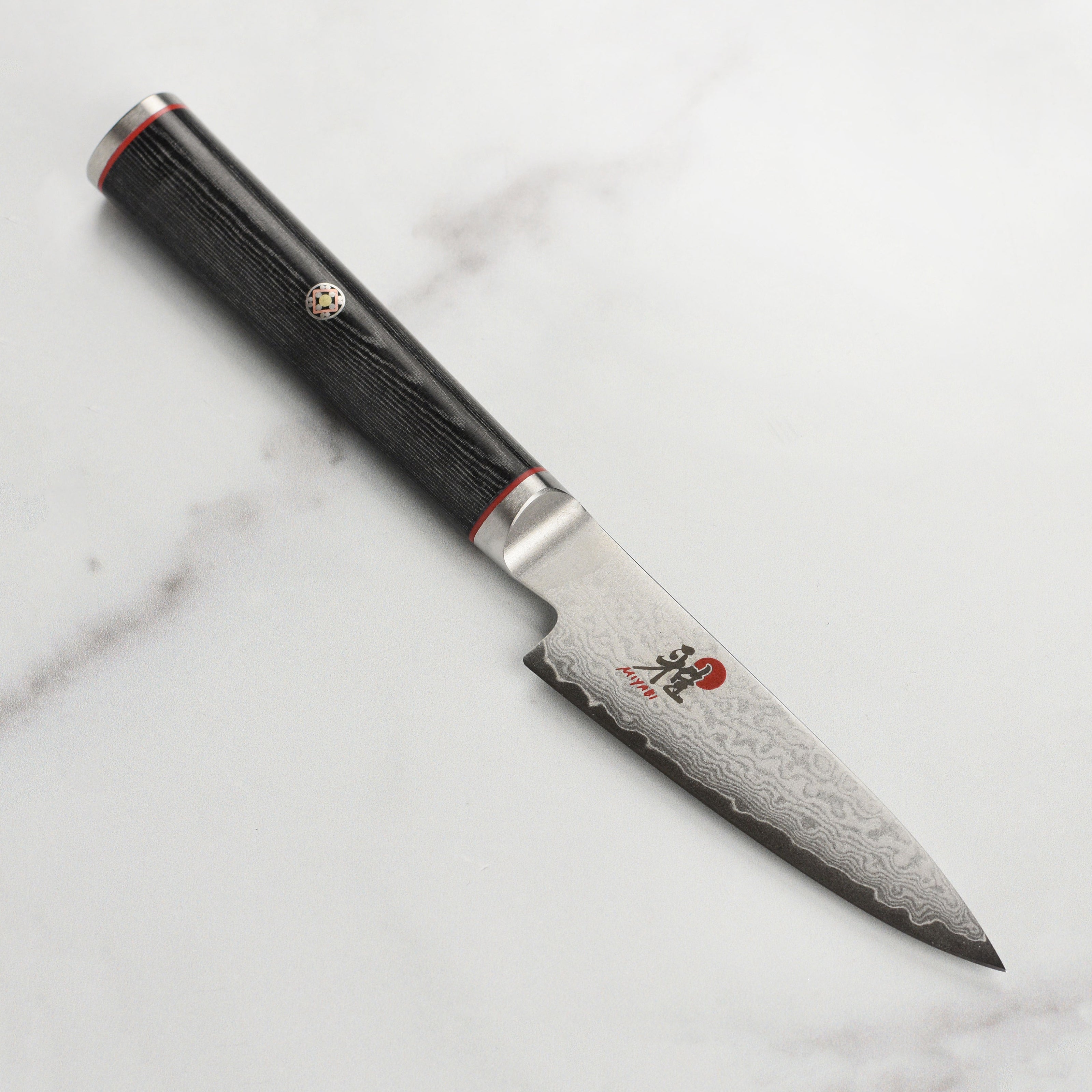Close-up of VG10 Damascus knife blade showing layered steel pattern
