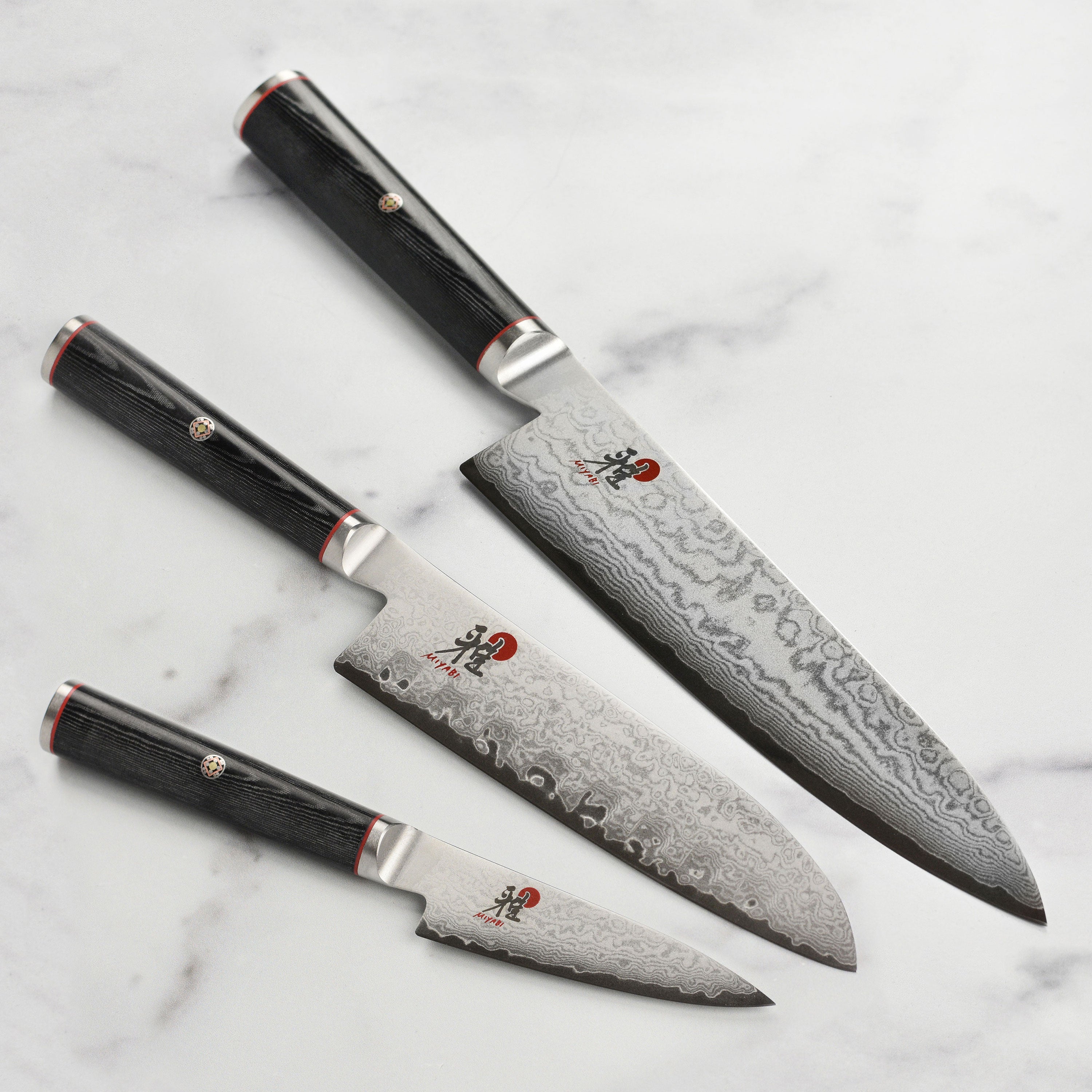 Miyabi Damascus 3-piece knife set displaying sharp blades and elegant handles, ideal for cooking enthusiasts.