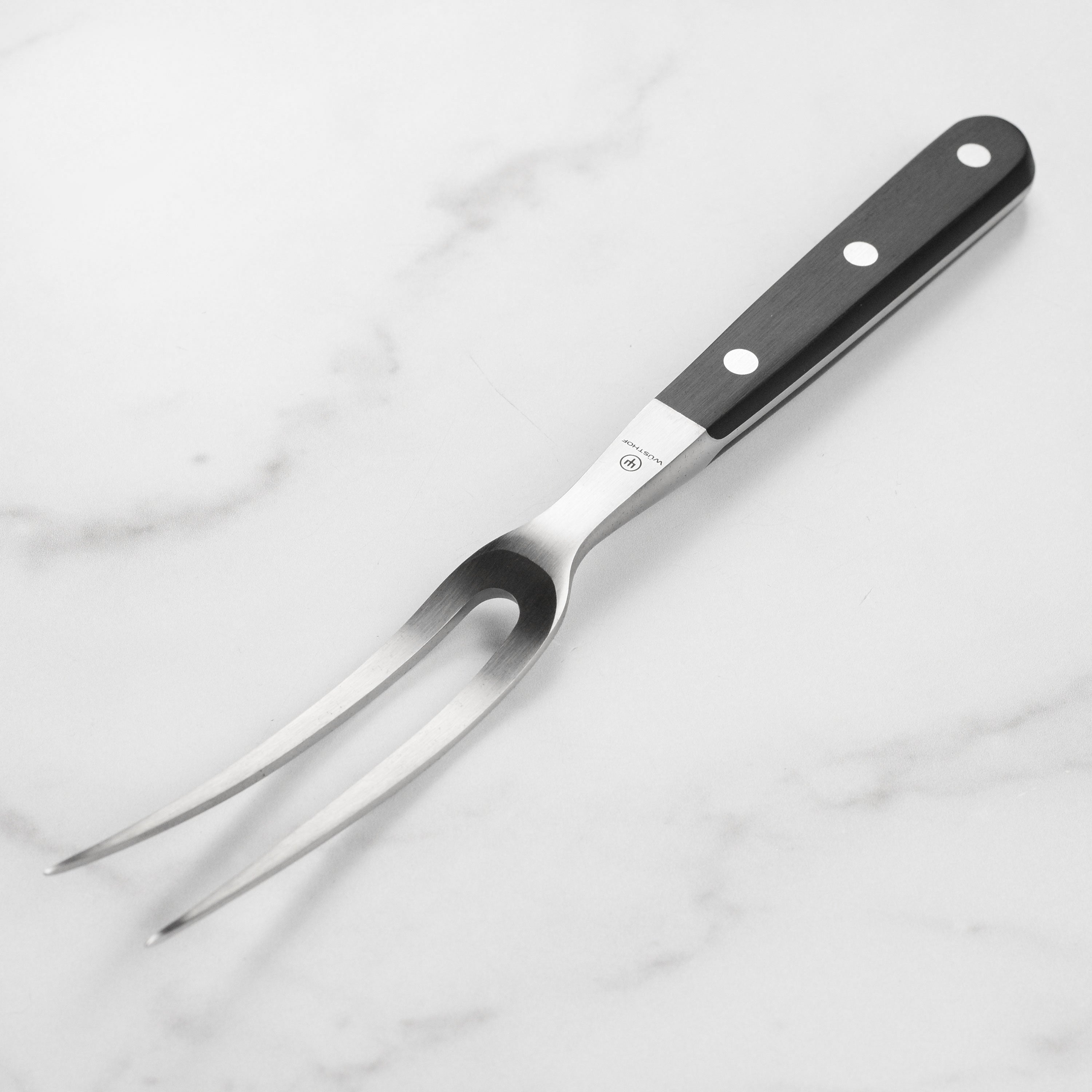Close-up of the Wusthof Classic carving fork displaying its dual prongs and ergonomic handle.