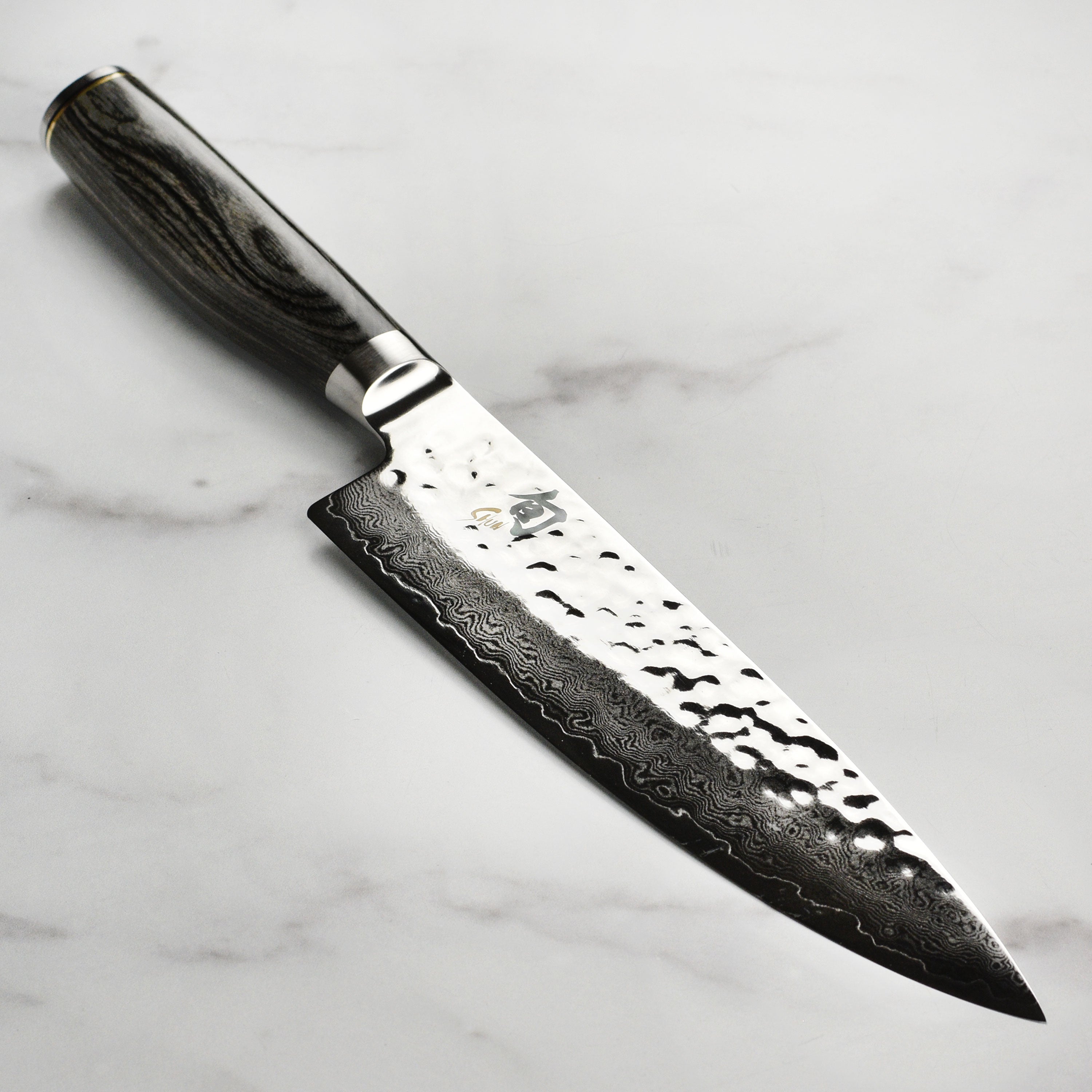 Close-up view of the Shun Premier Damascus 8-Inch Chef's Knife highlighting the Damascus pattern and edge.