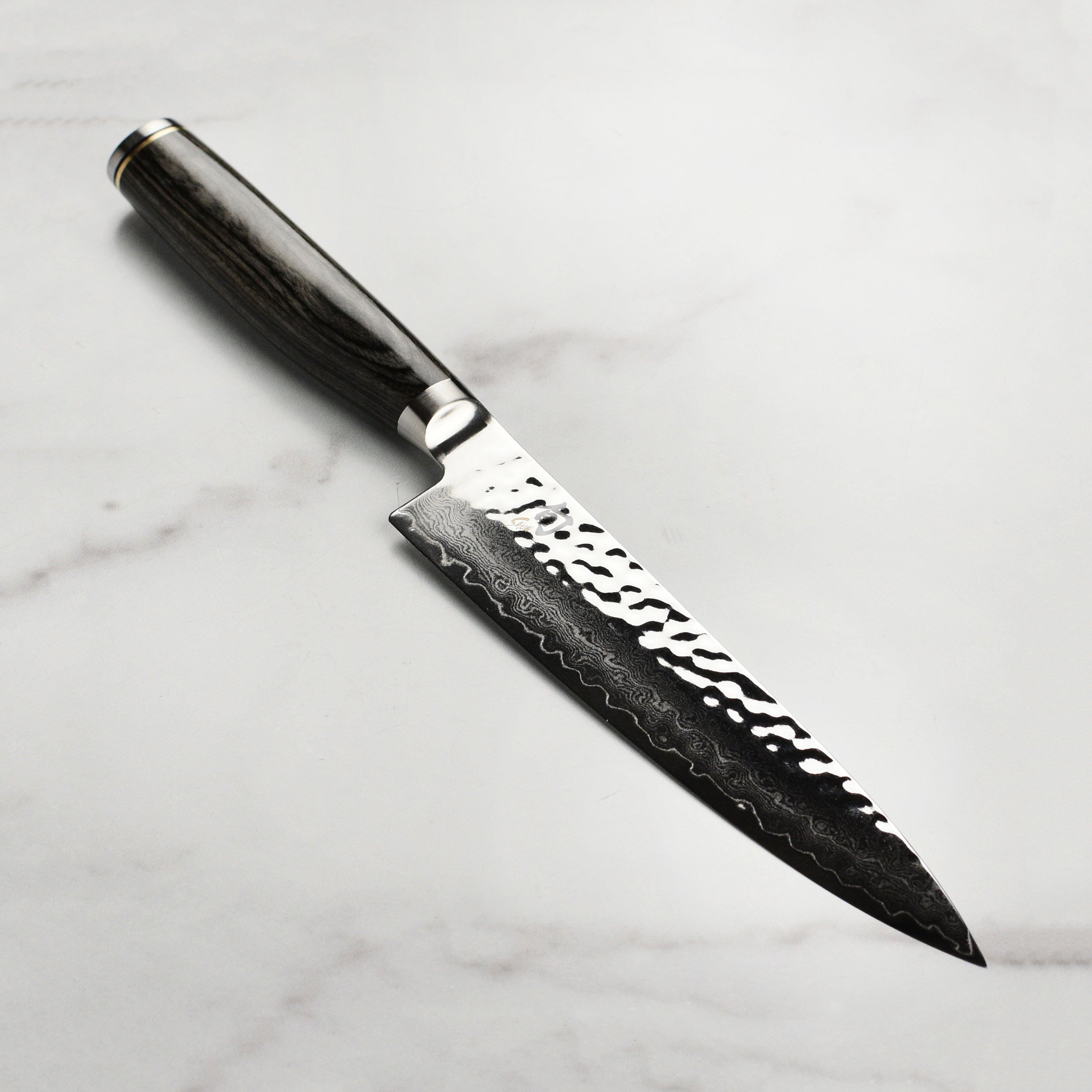 Shun Premier Grey Utility Knife showcasing the sleek design and Damascus blade.