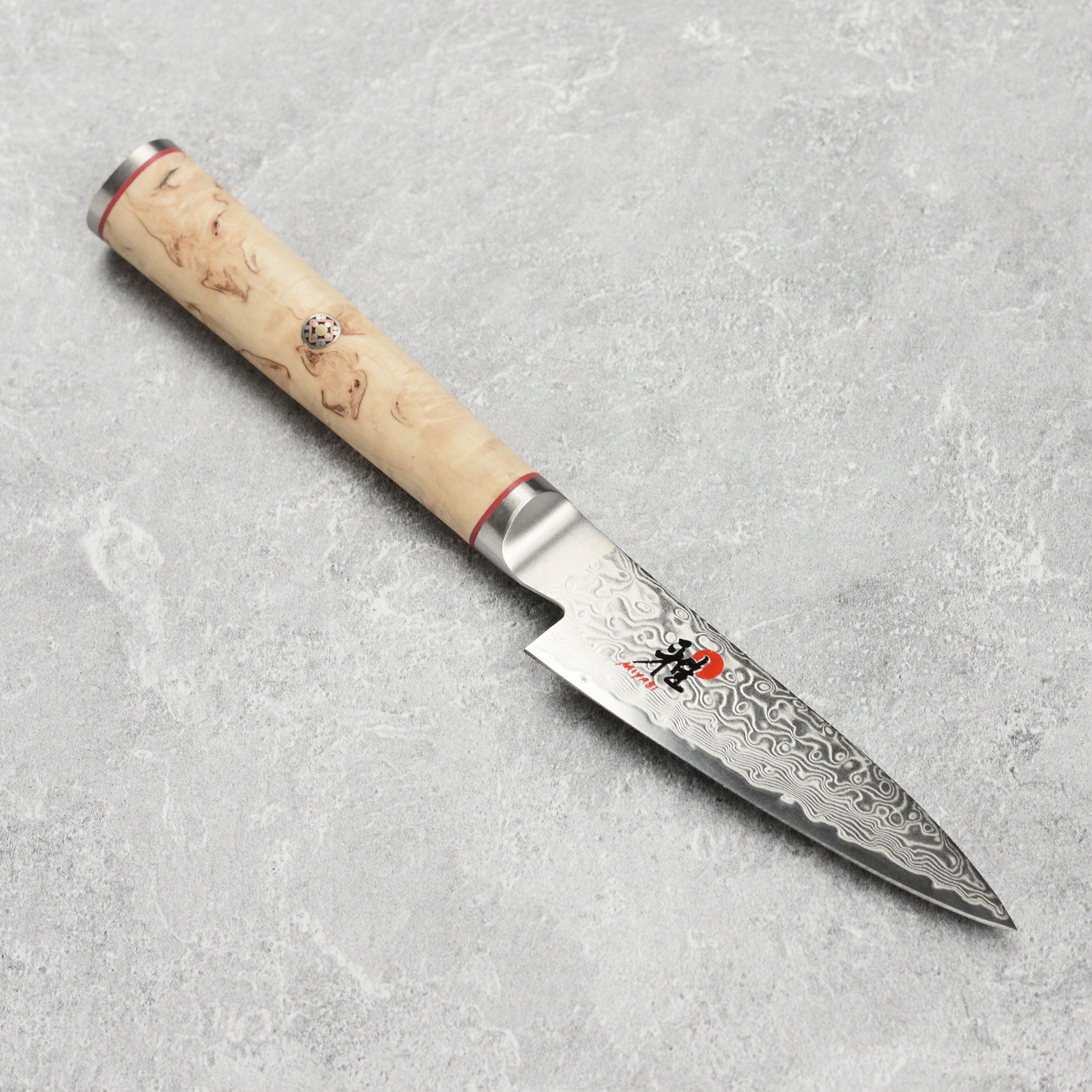 Close-up of the Miyabi Birchwood SG2 paring knife showing the detailed Damascus steel pattern.