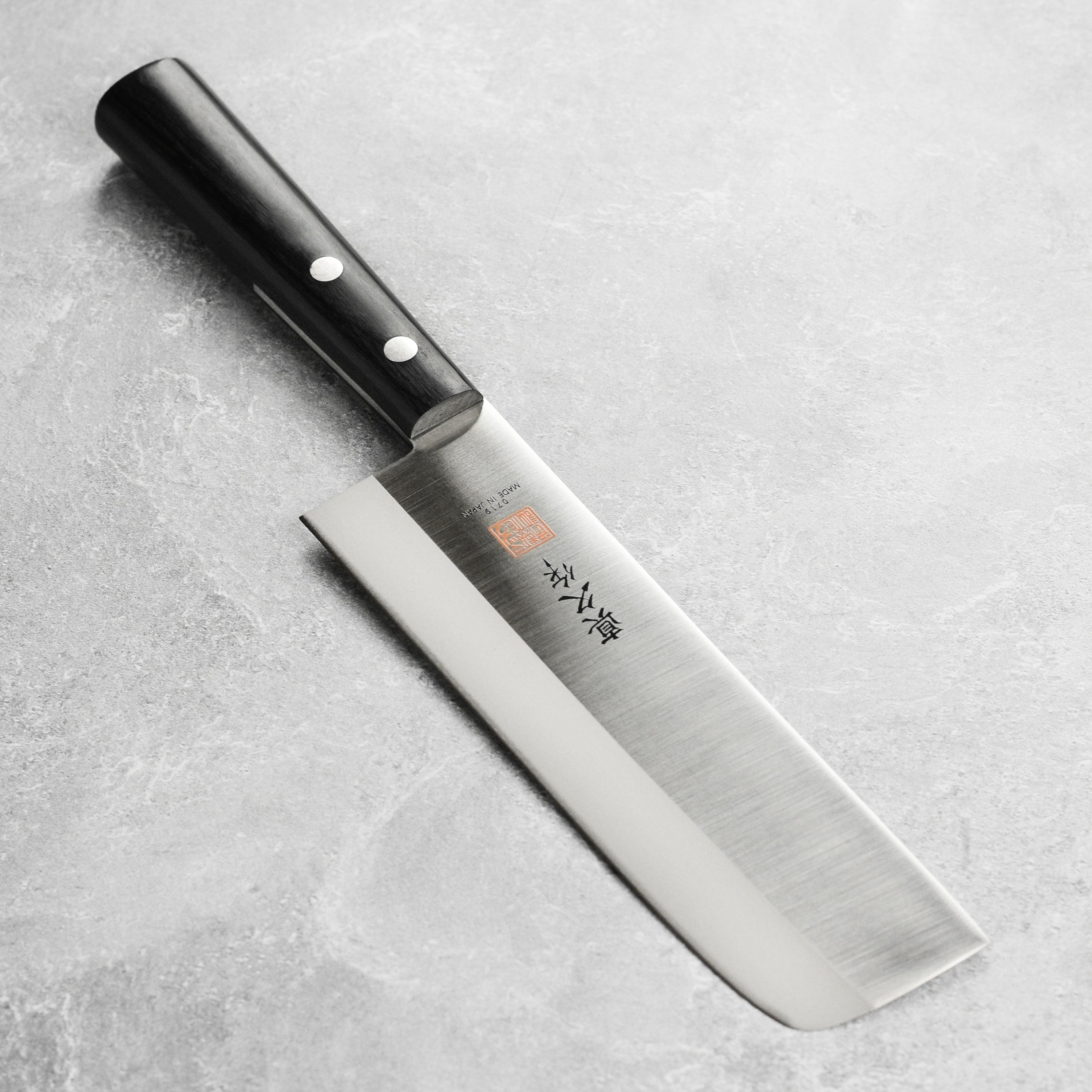 Close-up of the MAC 6.5-Inch Nakiri knife blade, highlighting its sharpness and craftsmanship.