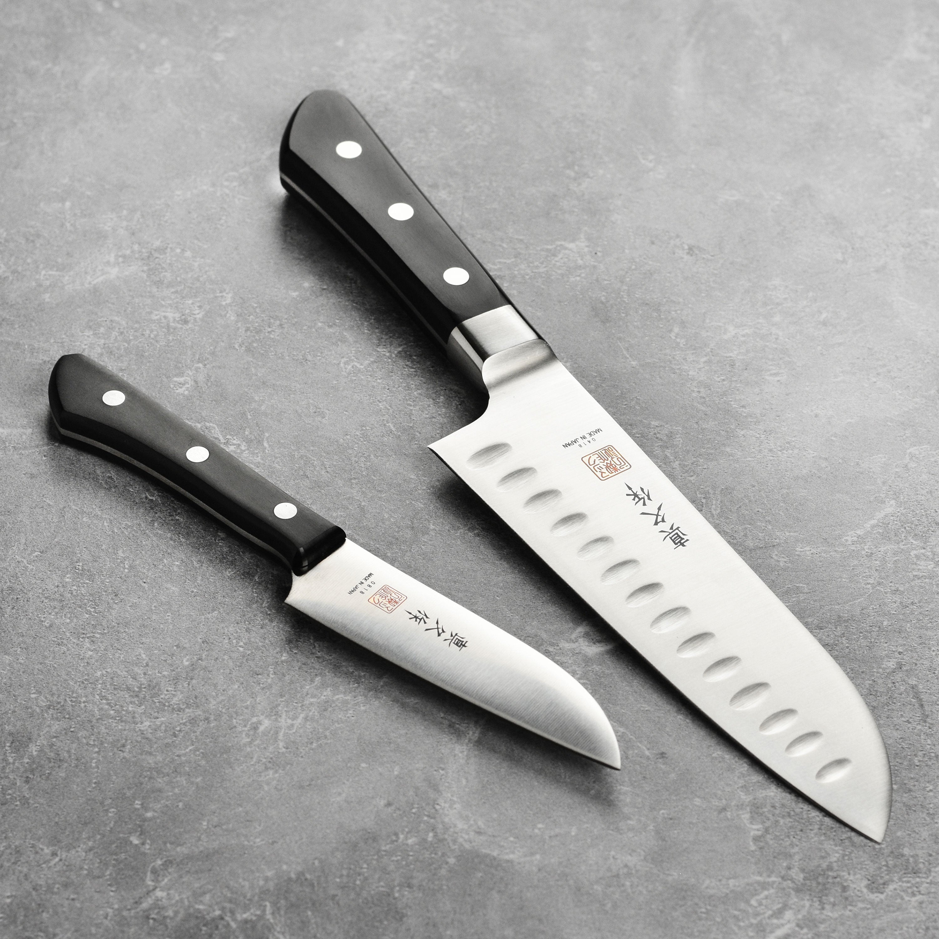 Premium MAC Santoku knife set showcasing the sleek design and precision blade angle.