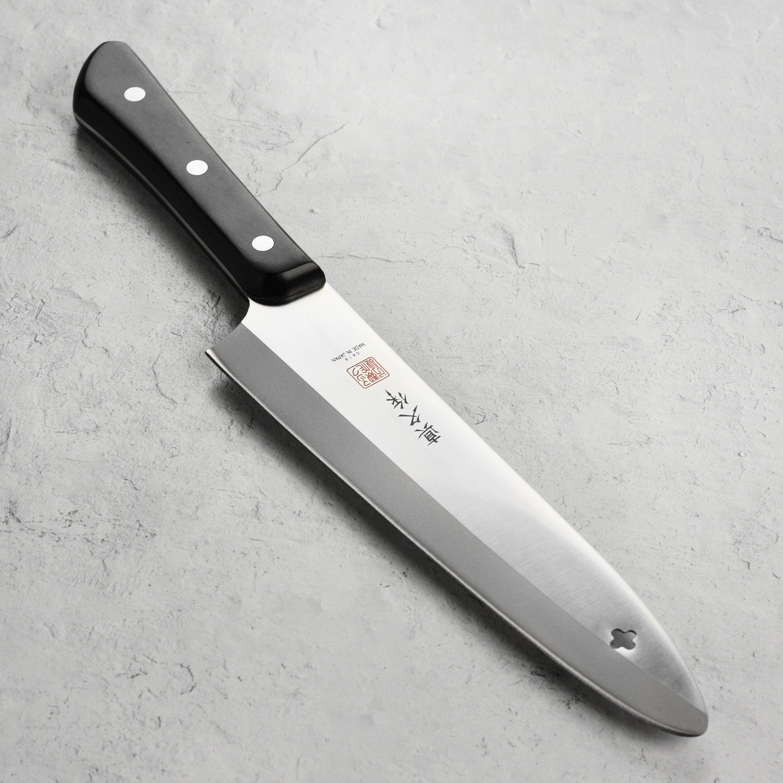 Close-up of the MAC Superior 8-Inch Chef's Knife blade highlighting its high-carbon steel and precision edge.