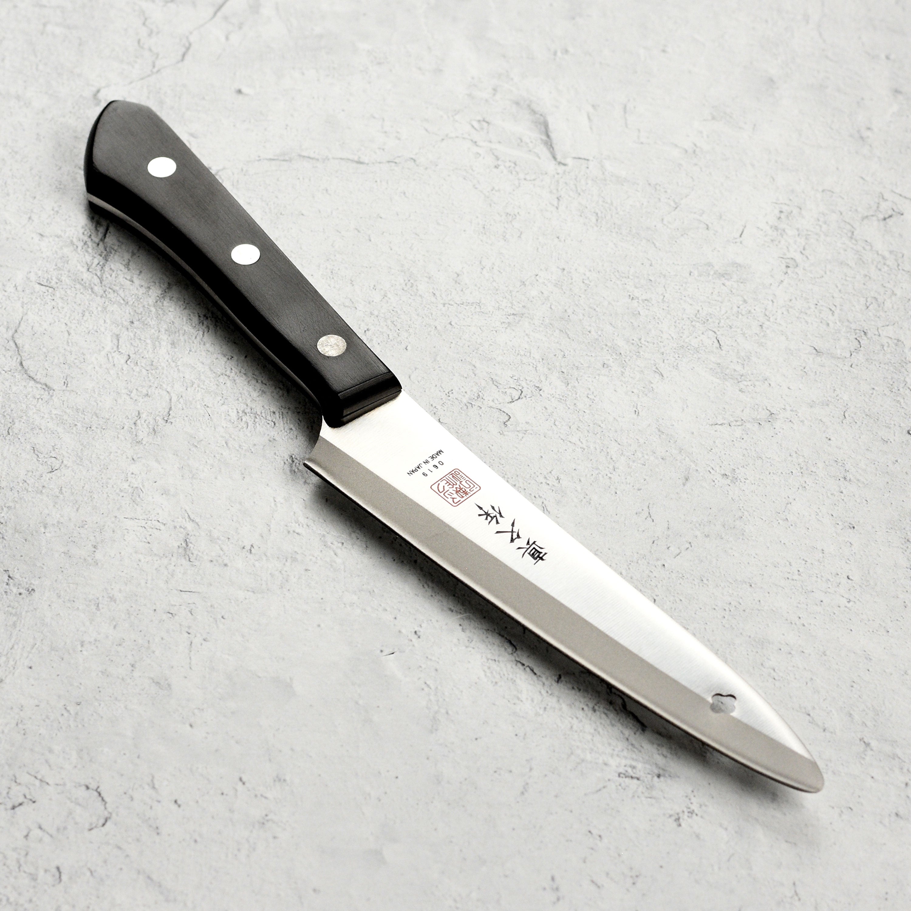 Close-up of MAC Superior Precision Utility Knife showcasing the razor-sharp blade and Pakkawood handle.