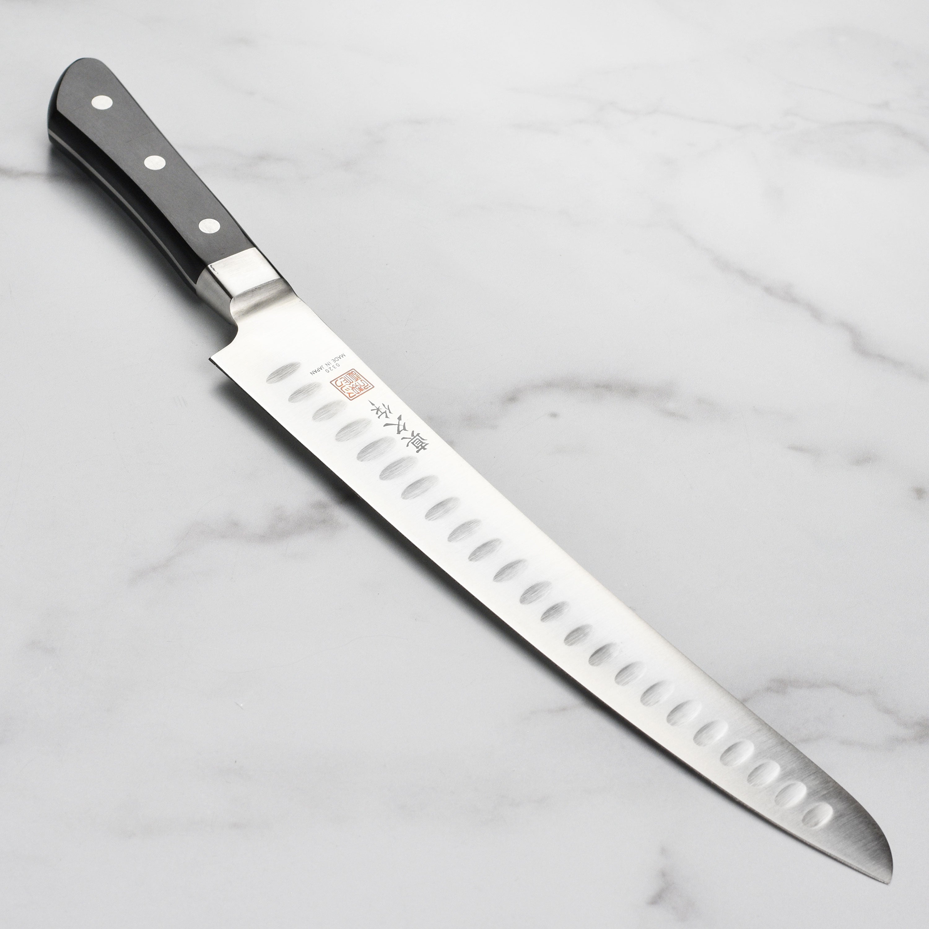 Close-up view of the Precision Chef's Hollow Edge Slicing Knife showcasing its sharp blade and Pakkawood handle.