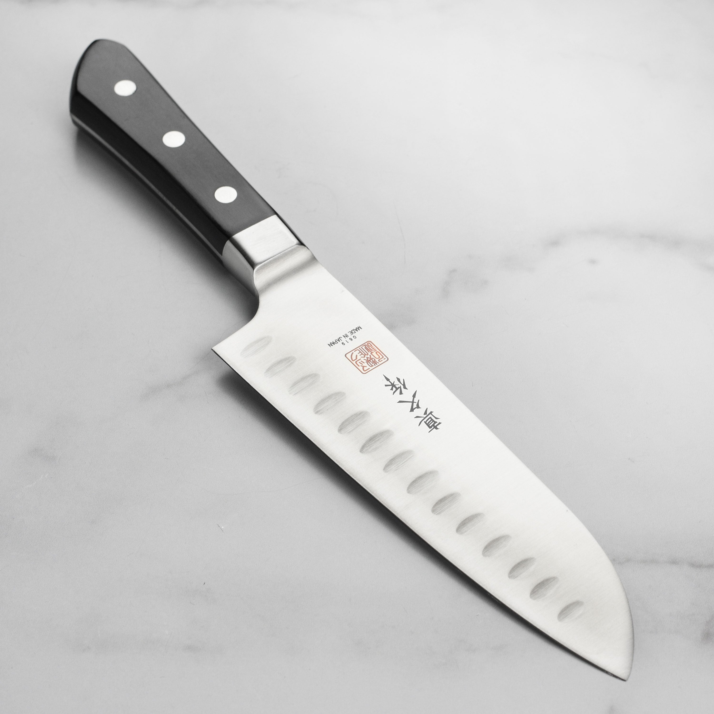 MAC Hollow Edge Santoku Knife - angled view highlighting the blade