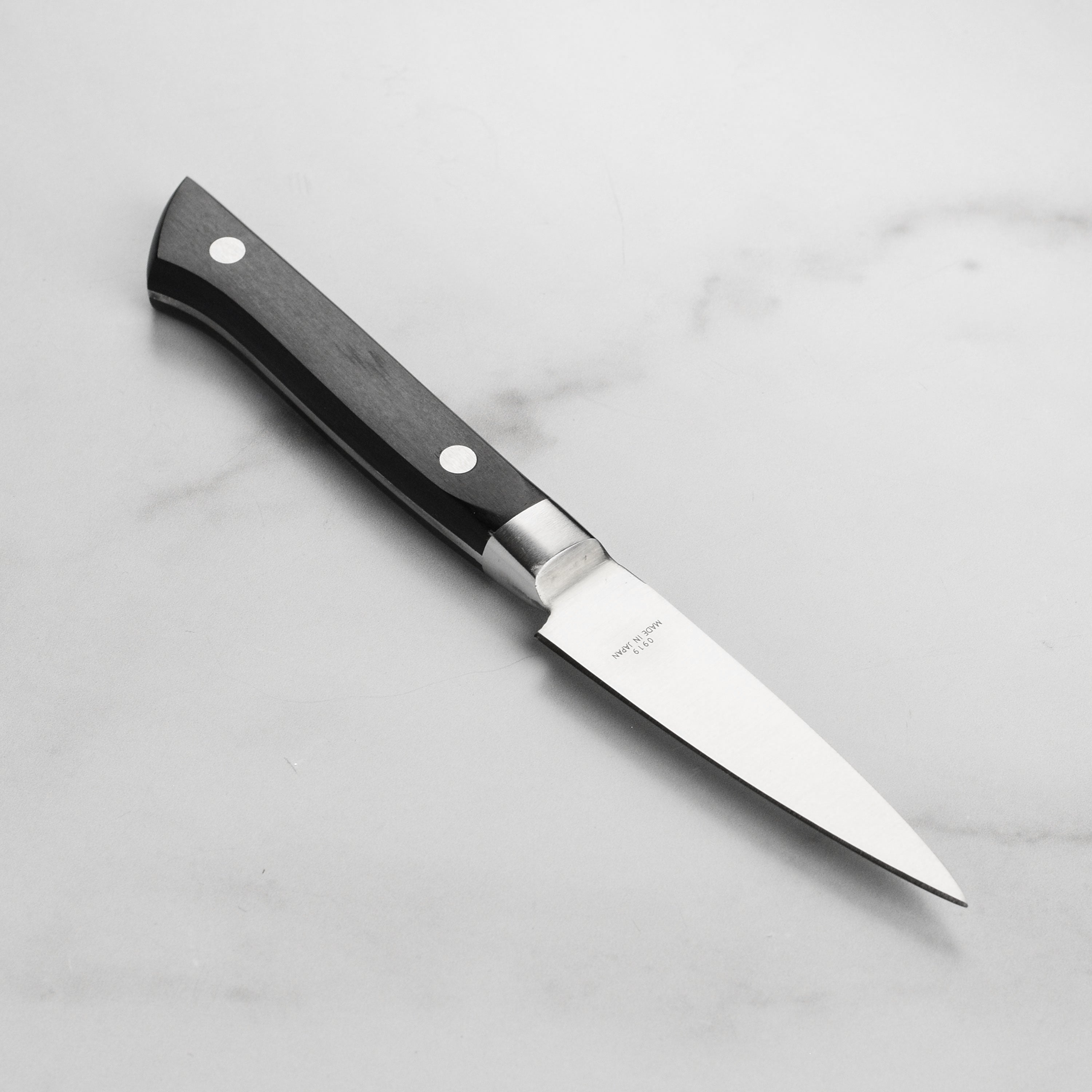 Close-up of PrecisionEdge Japanese paring knife showcasing its high carbon steel blade and Pakkawood handle.