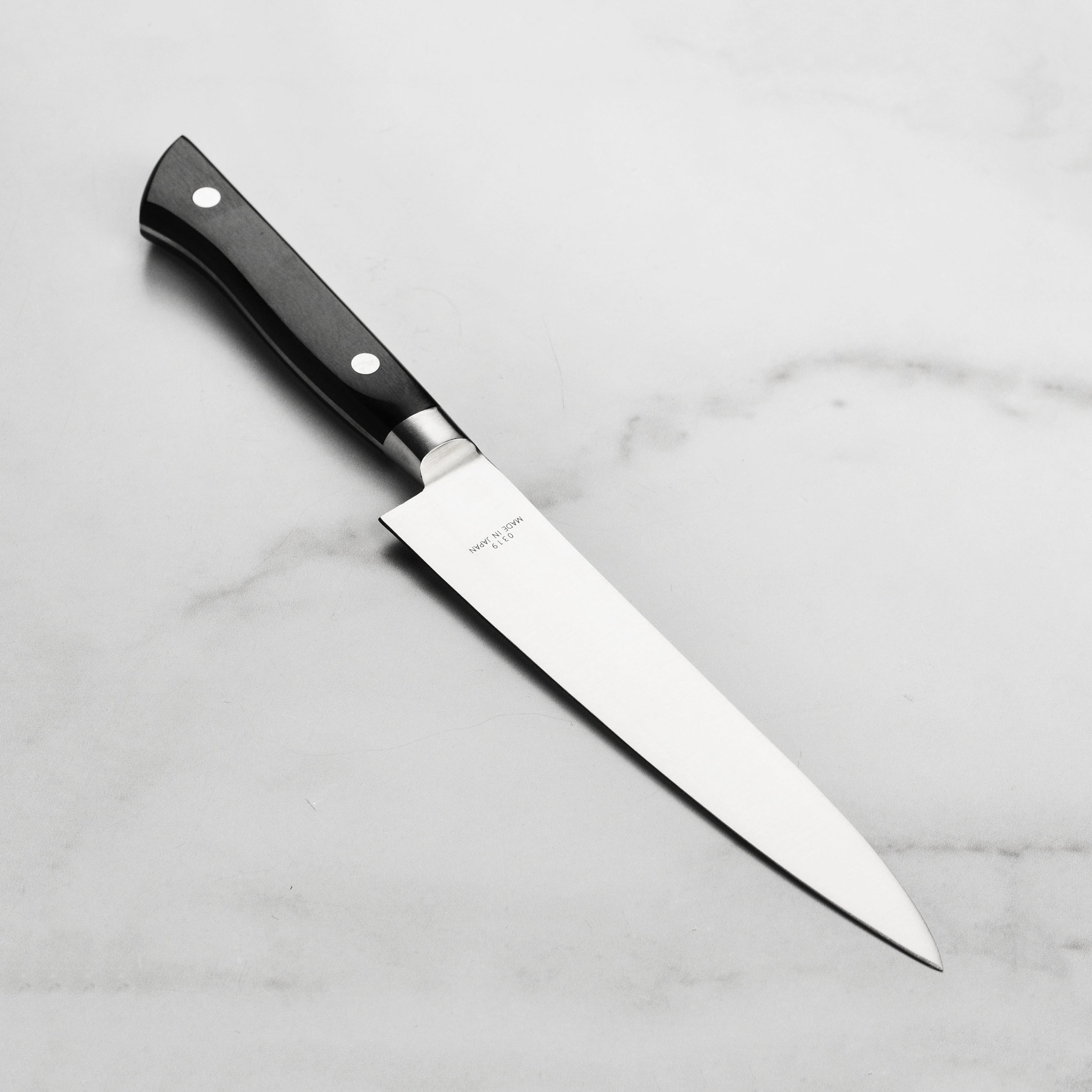 Close-up of the MAC 6-Inch Chef Utility Knife blade highlighting its sharpness and craftsmanship.