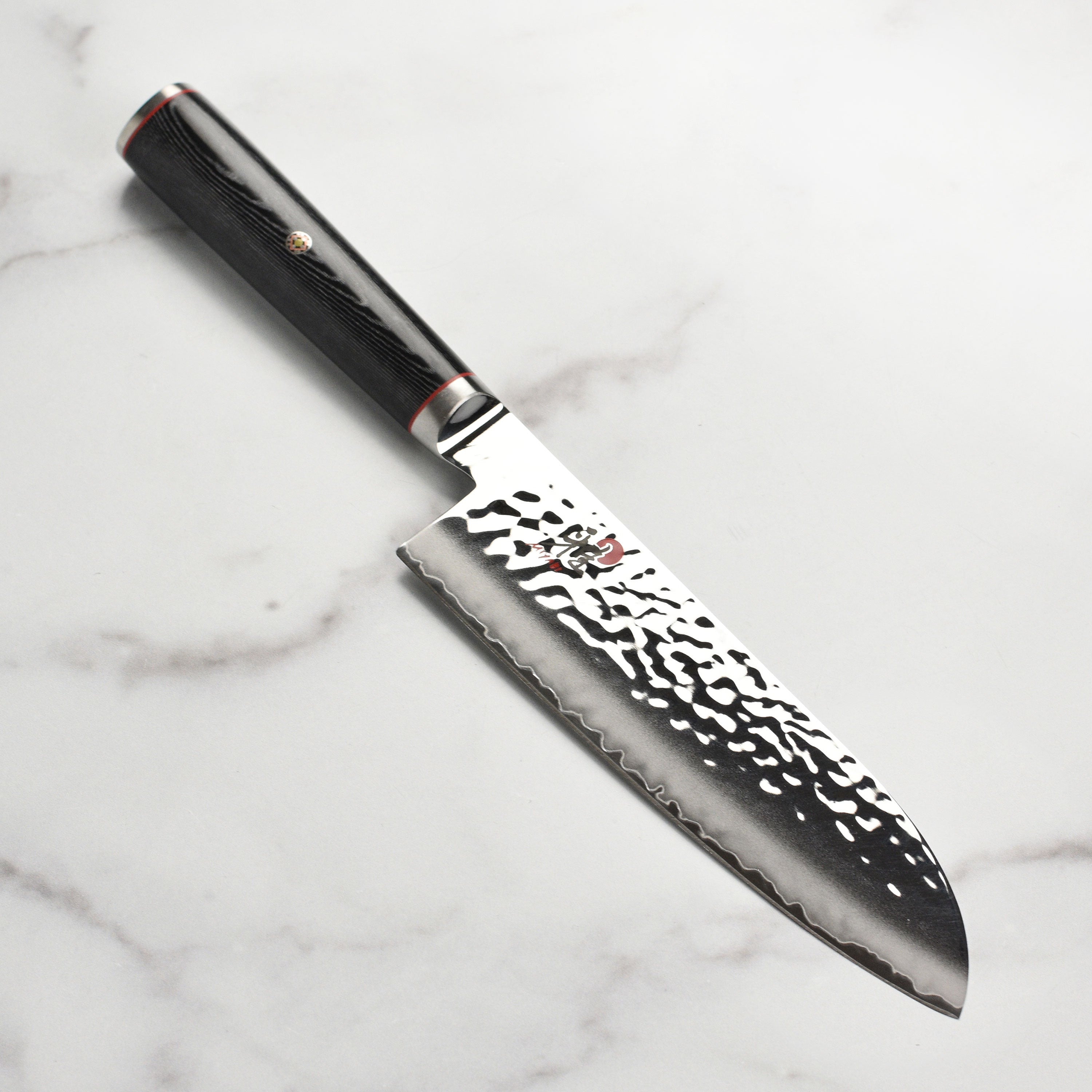 Miyabi Mizu SG2 Santoku knife showing the blade and handle design, perfect for culinary tasks.