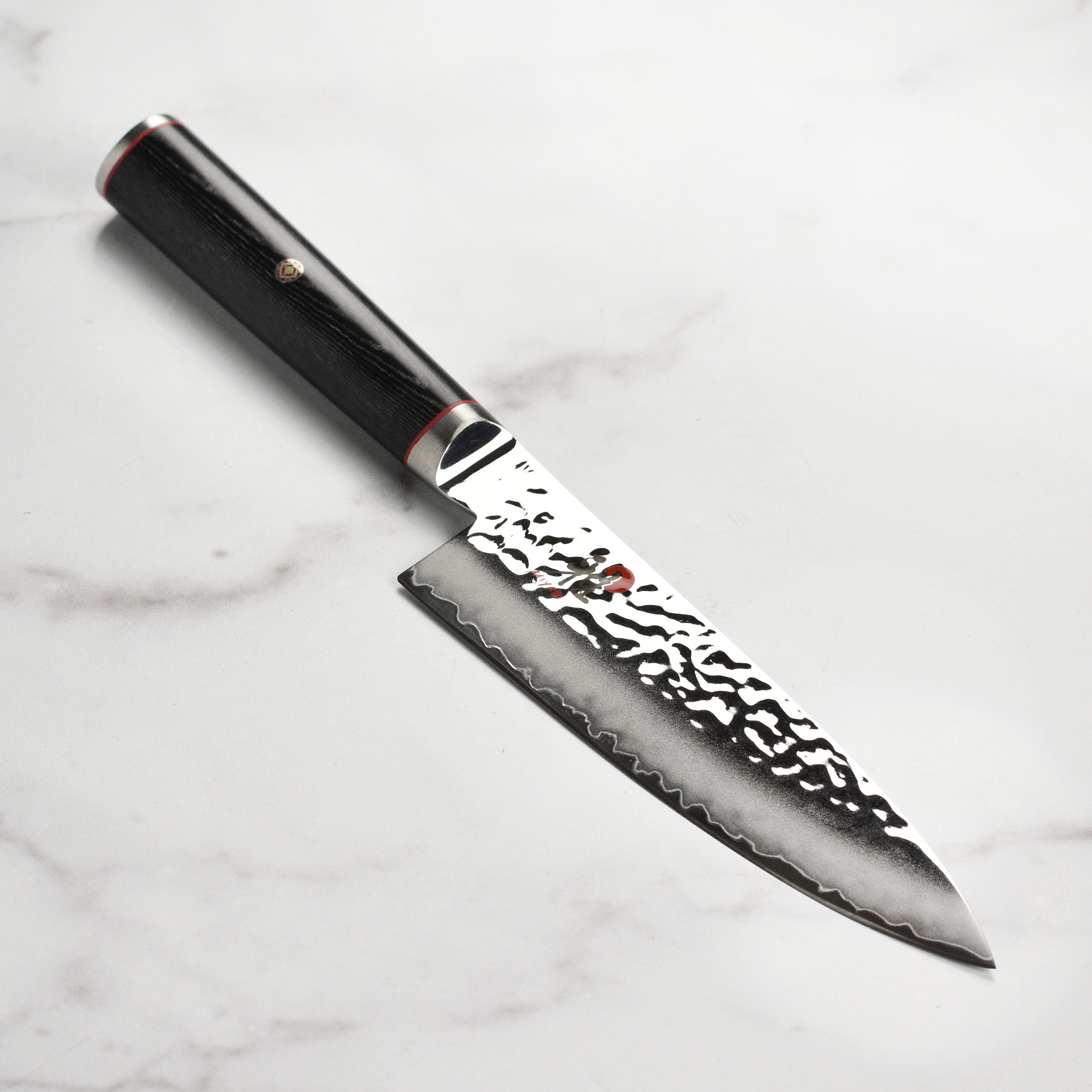 Miyabi Mizu SG2 chef's knife showcasing the Damascus steel finish and ergonomic handle.