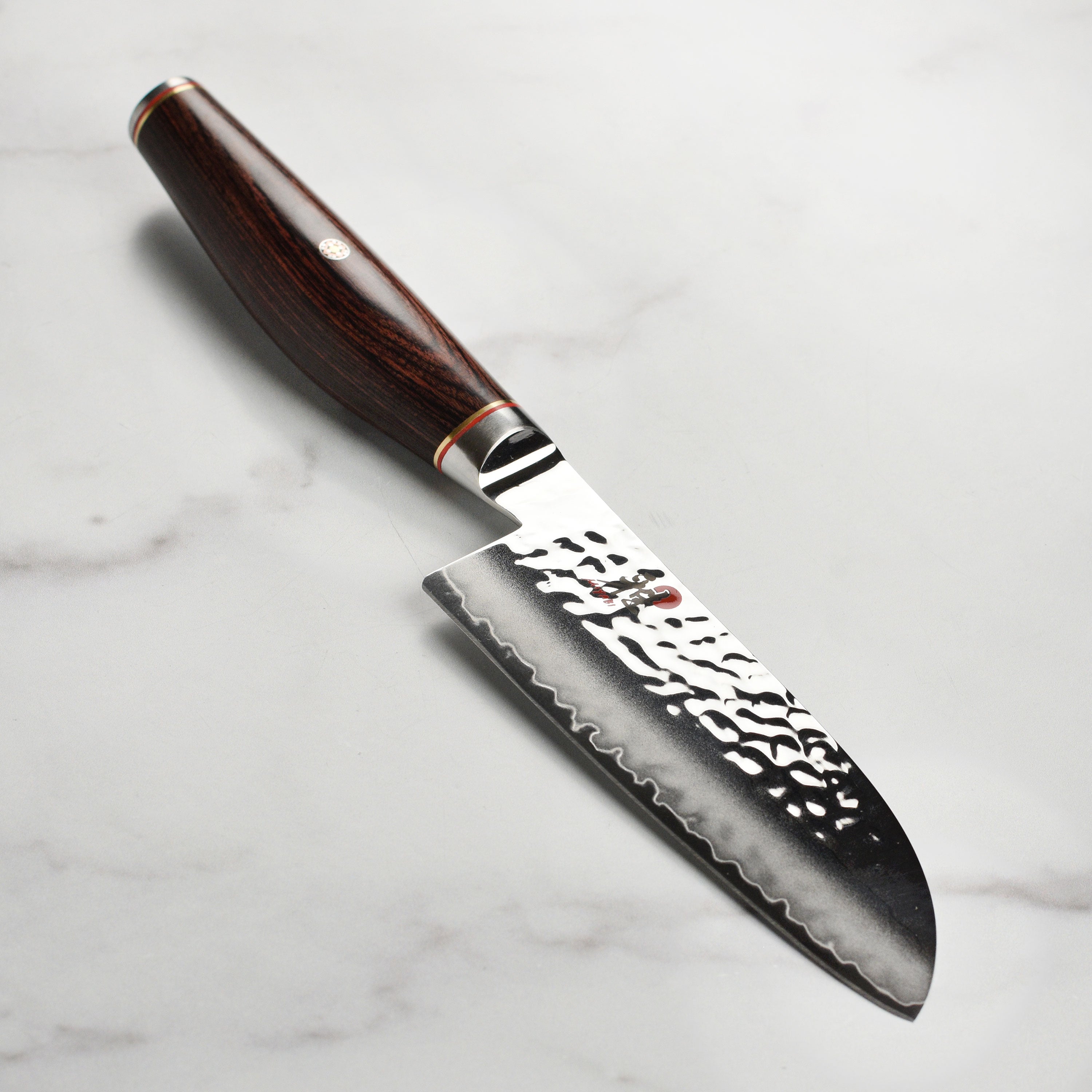 Miyabi Artisan SG2 5.5 inch Santoku knife blade with Damascus textured finish, perfect for professional chefs