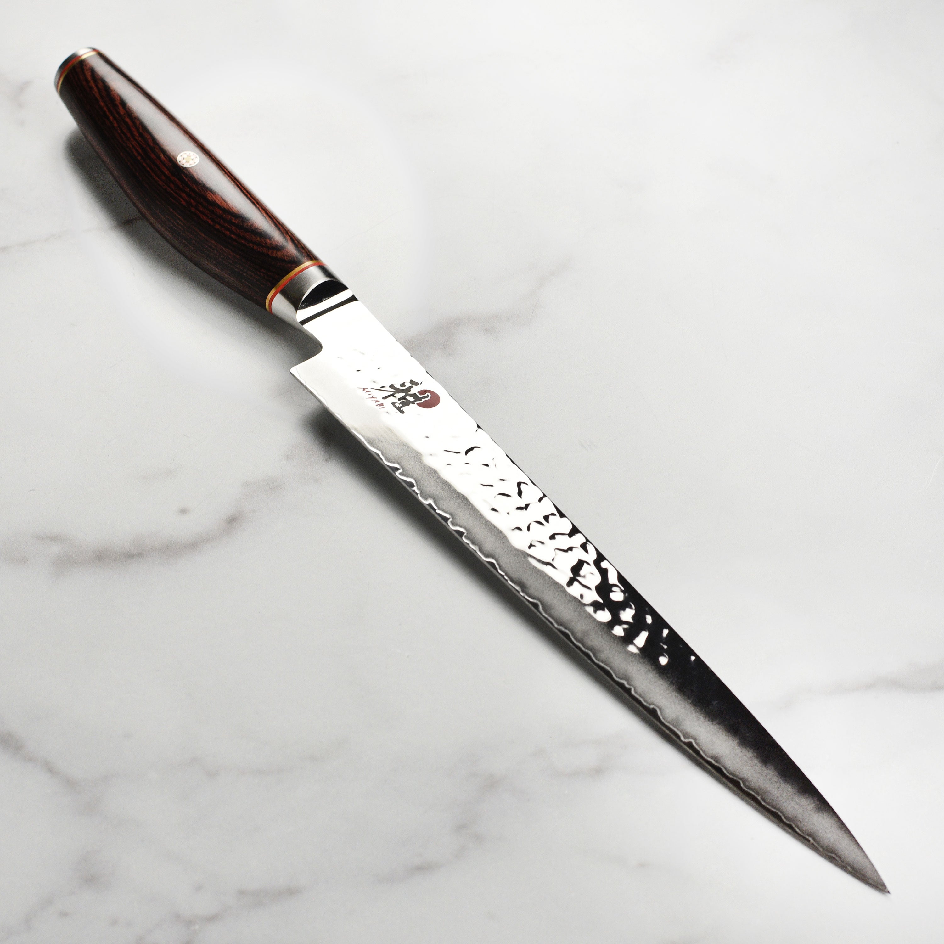 Top view of Japanese slicing knife showcasing Damascus steel finish