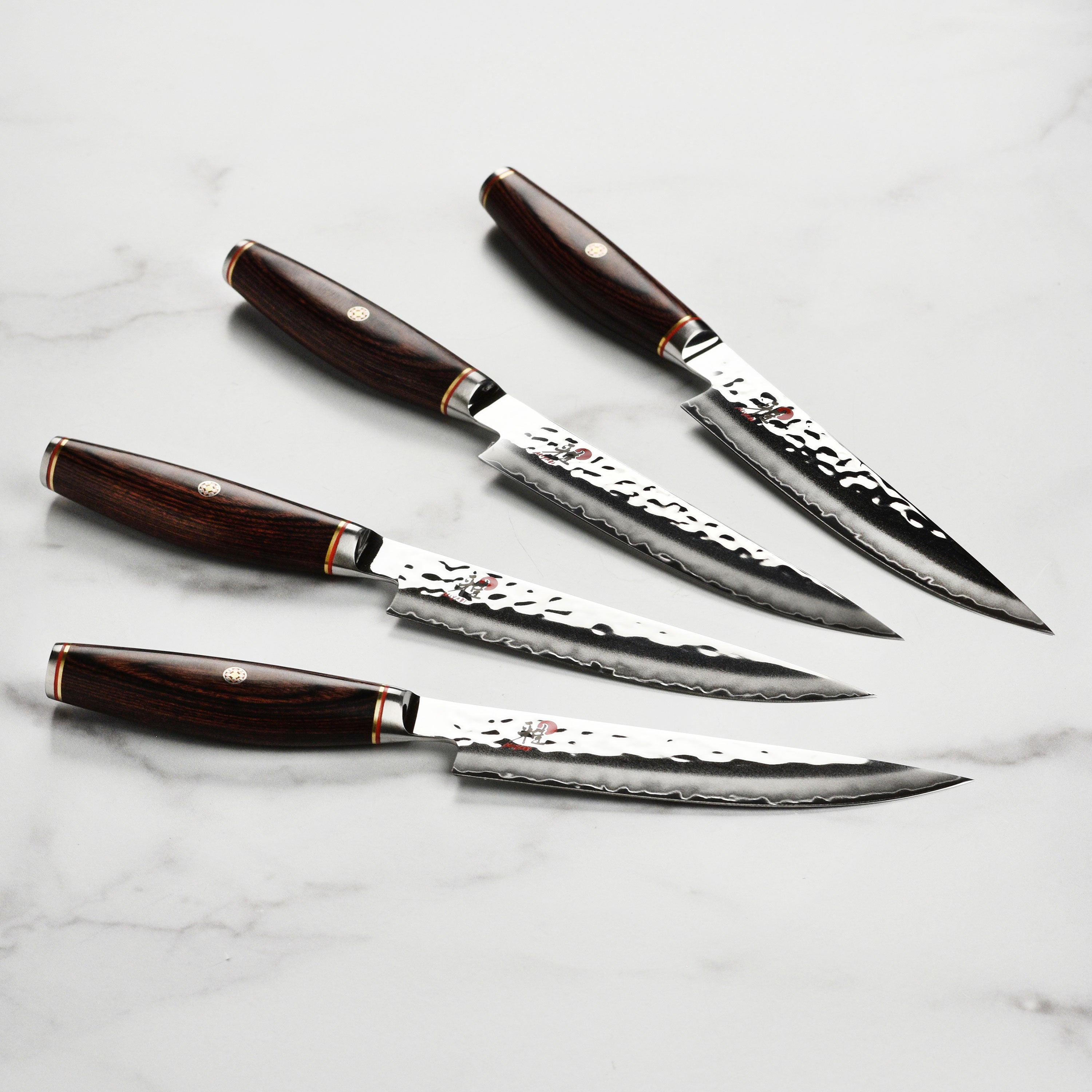 Angled side profile of SG2 Damascus steak knife showcasing layered steel and hammered texture