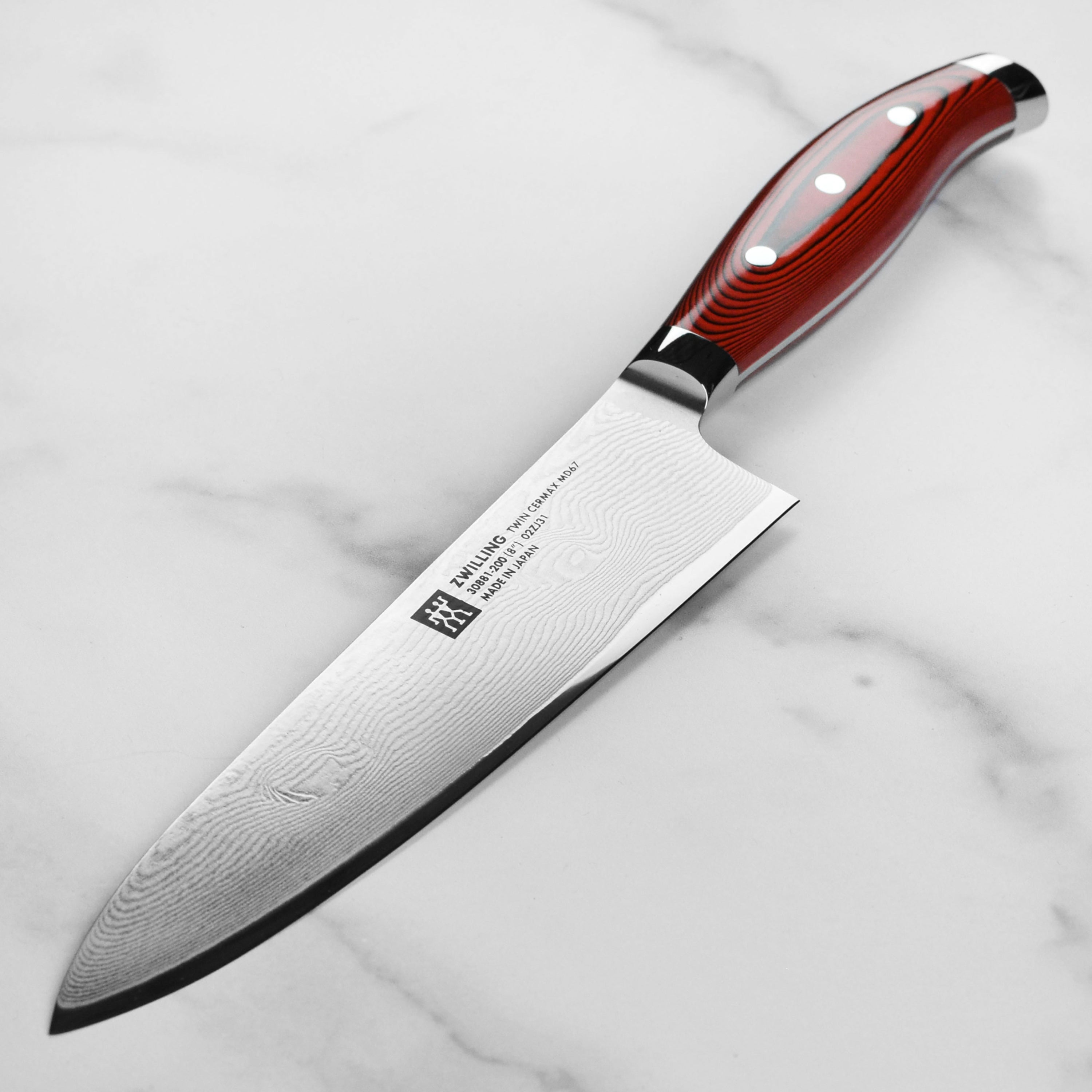 Close-up of Damascus knife blade showcasing 133-layer rippling steel finish