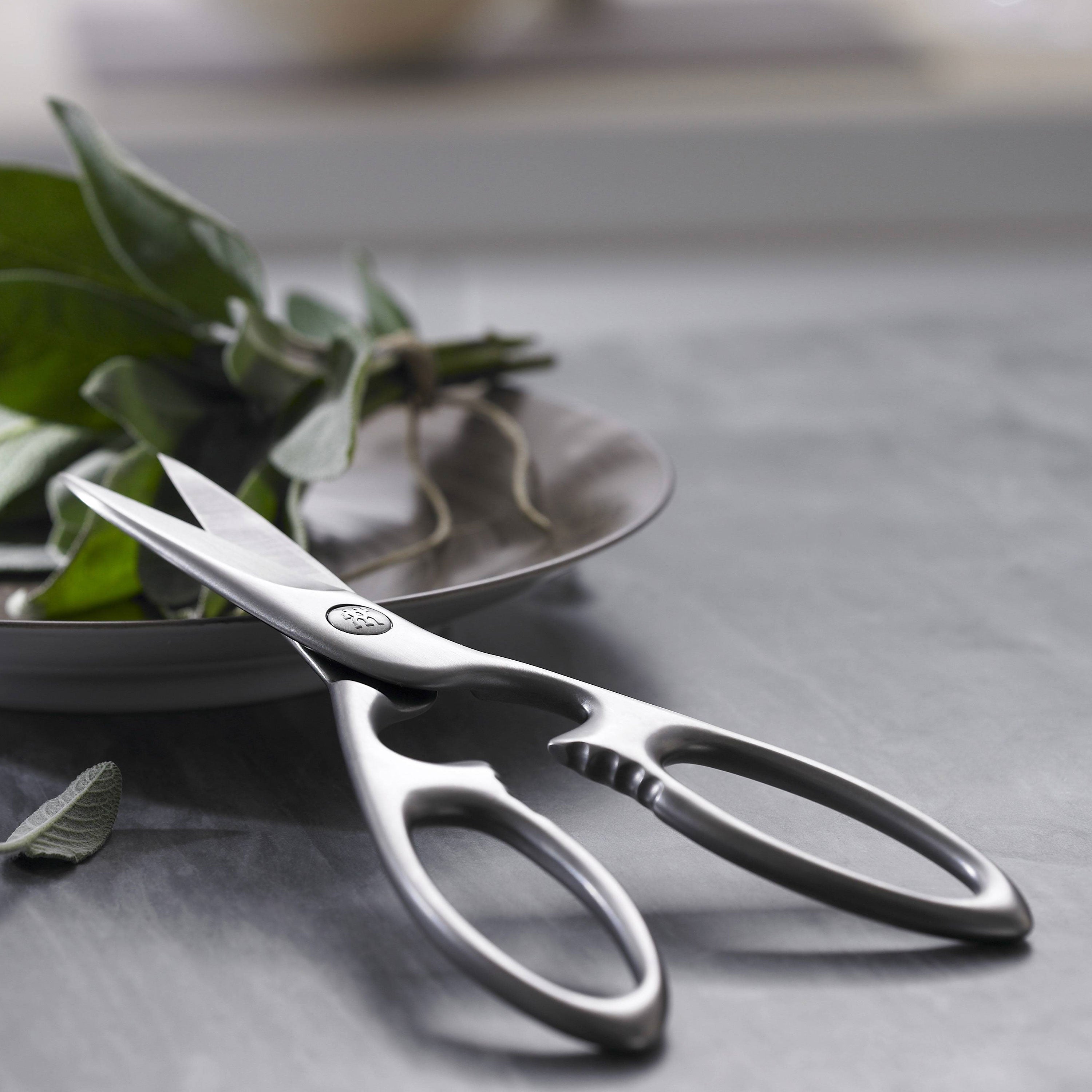 Premium stainless steel kitchen shears with bottle opener, showcasing the sharp blades and ergonomic handle.