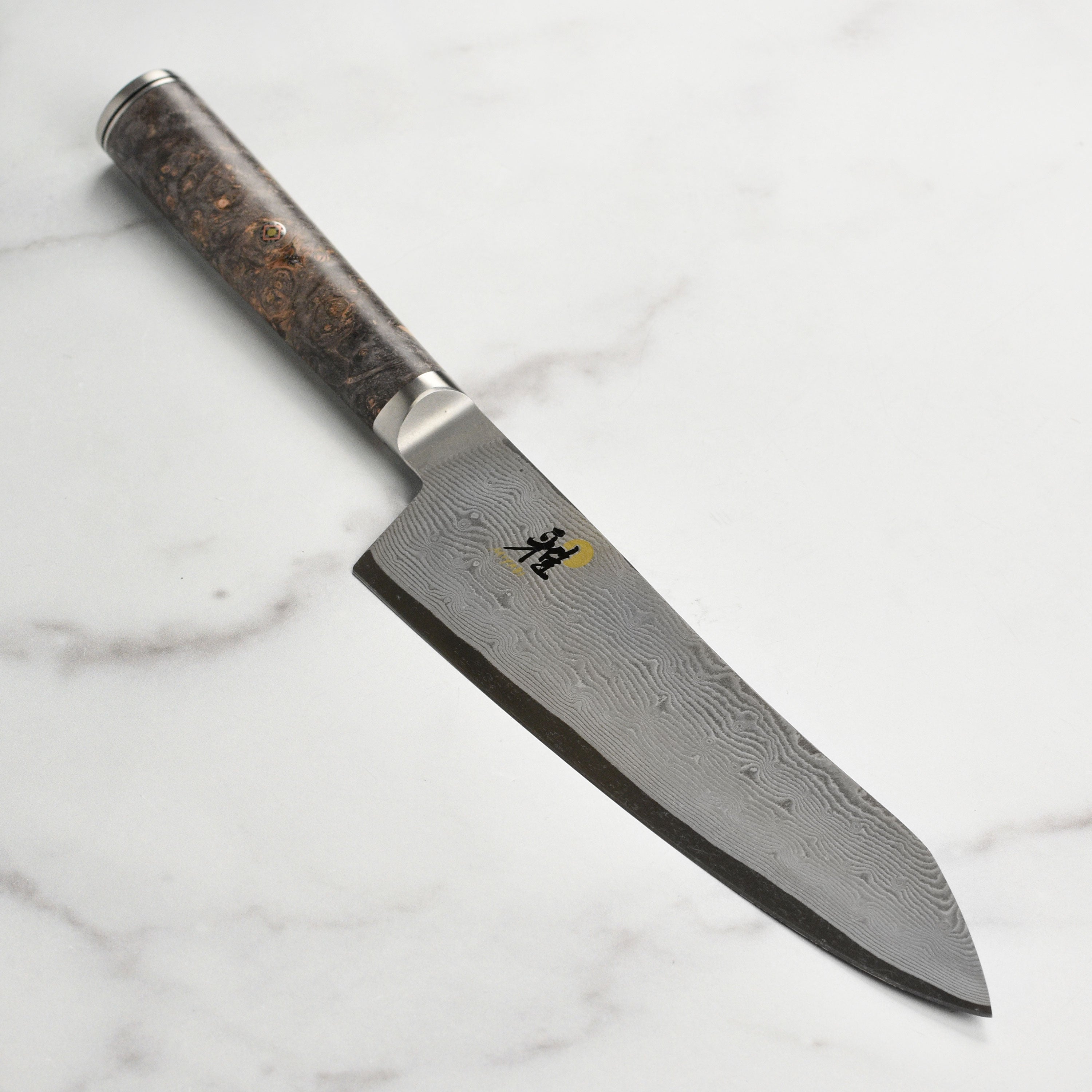 Miyabi Black 7-inch santoku knife with Damascus pattern and black handle for detailed kitchen prep