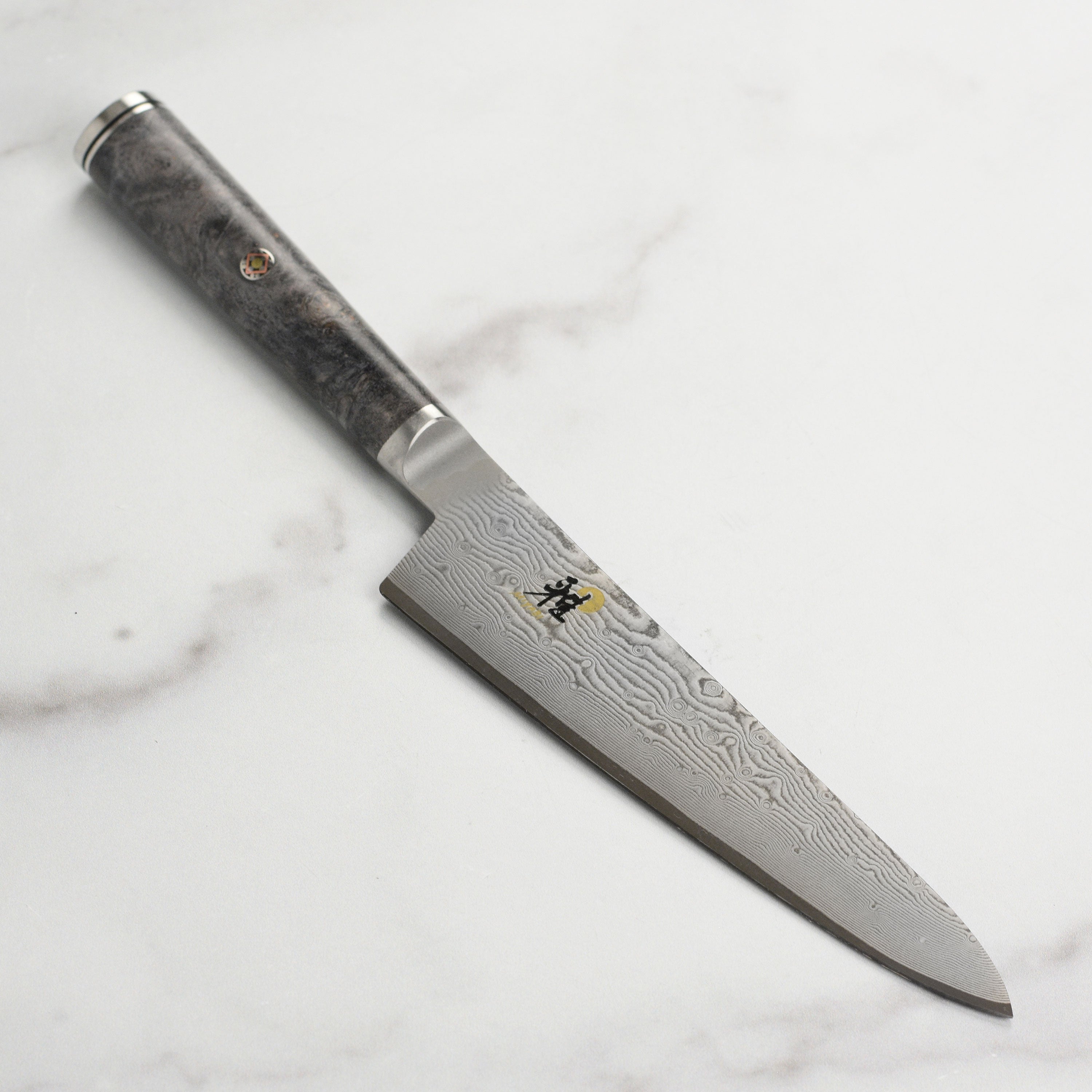 Damascus pattern on Miyabi Black prep knife highlighting layered steel construction