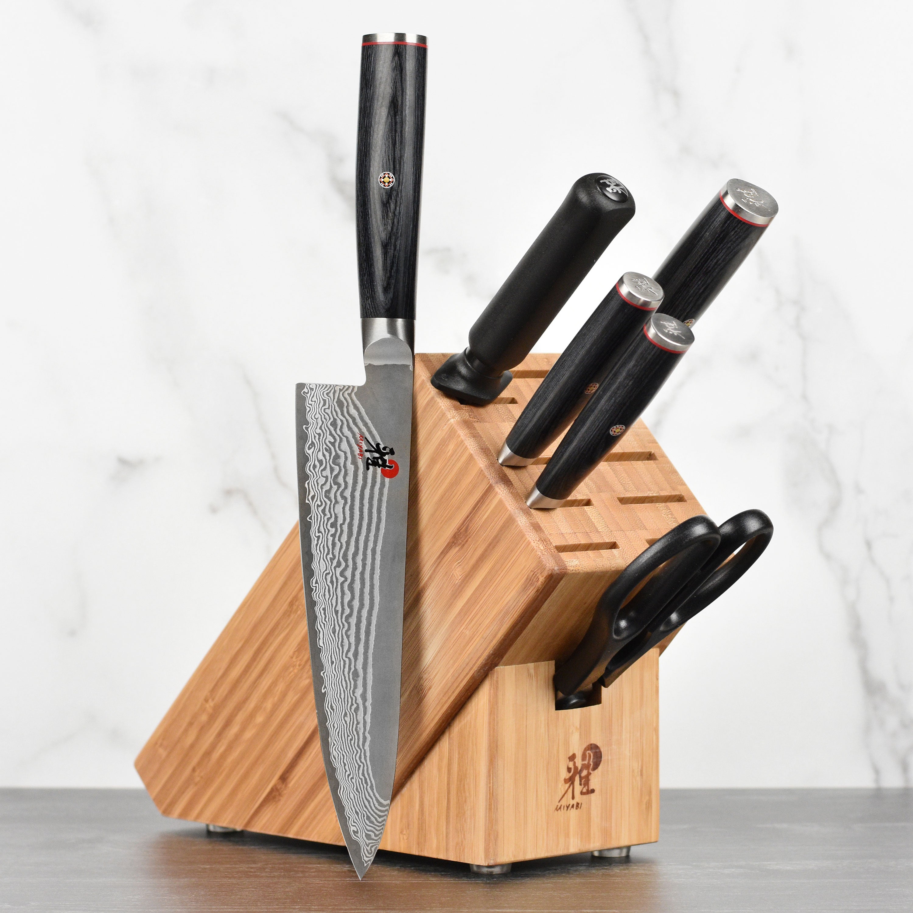 Close-up of Damascus steel blades on Japanese chef knives with intricate patterns