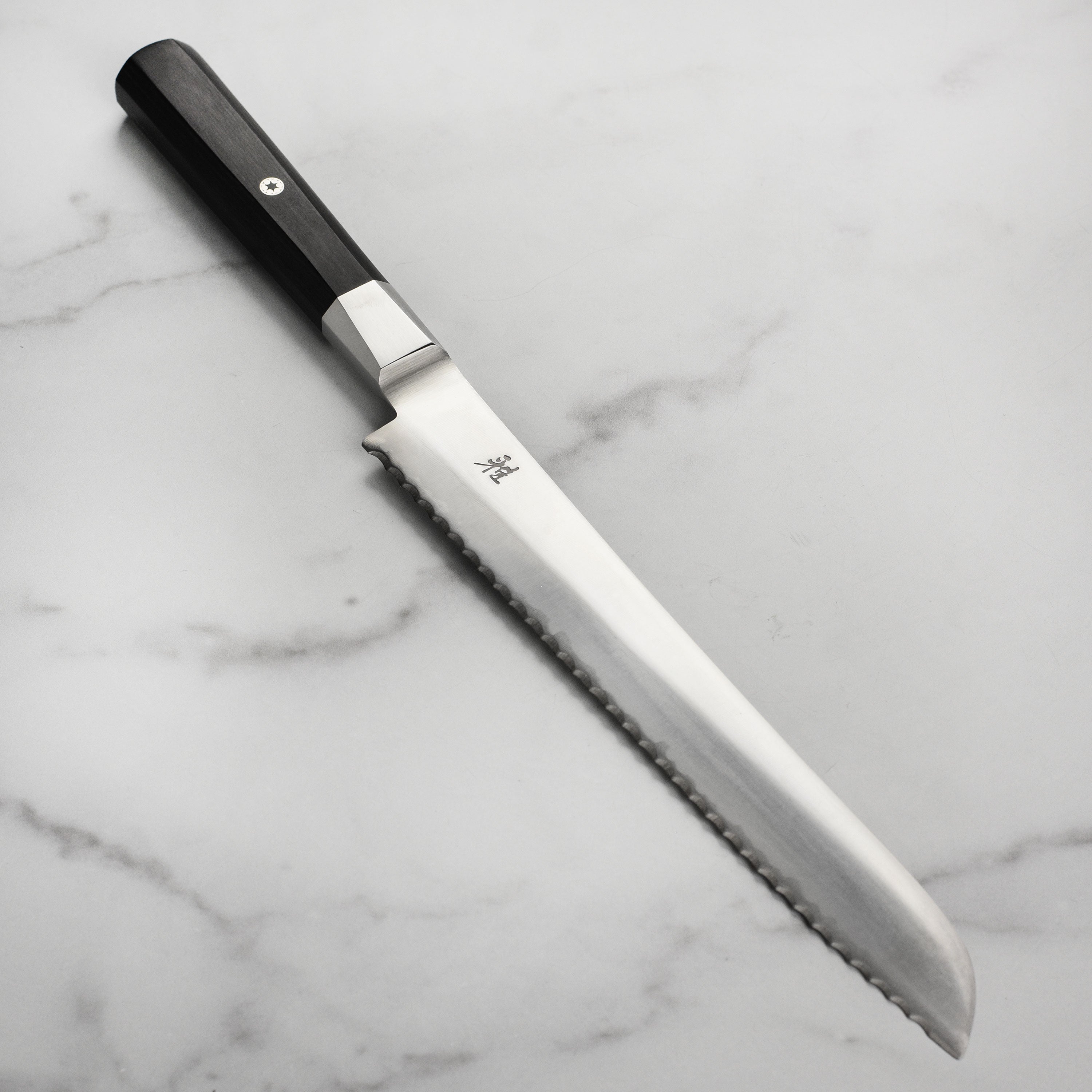 Miyabi Koh 9-inch bread knife with detailed blade and handle, ideal for slicing bread precisely