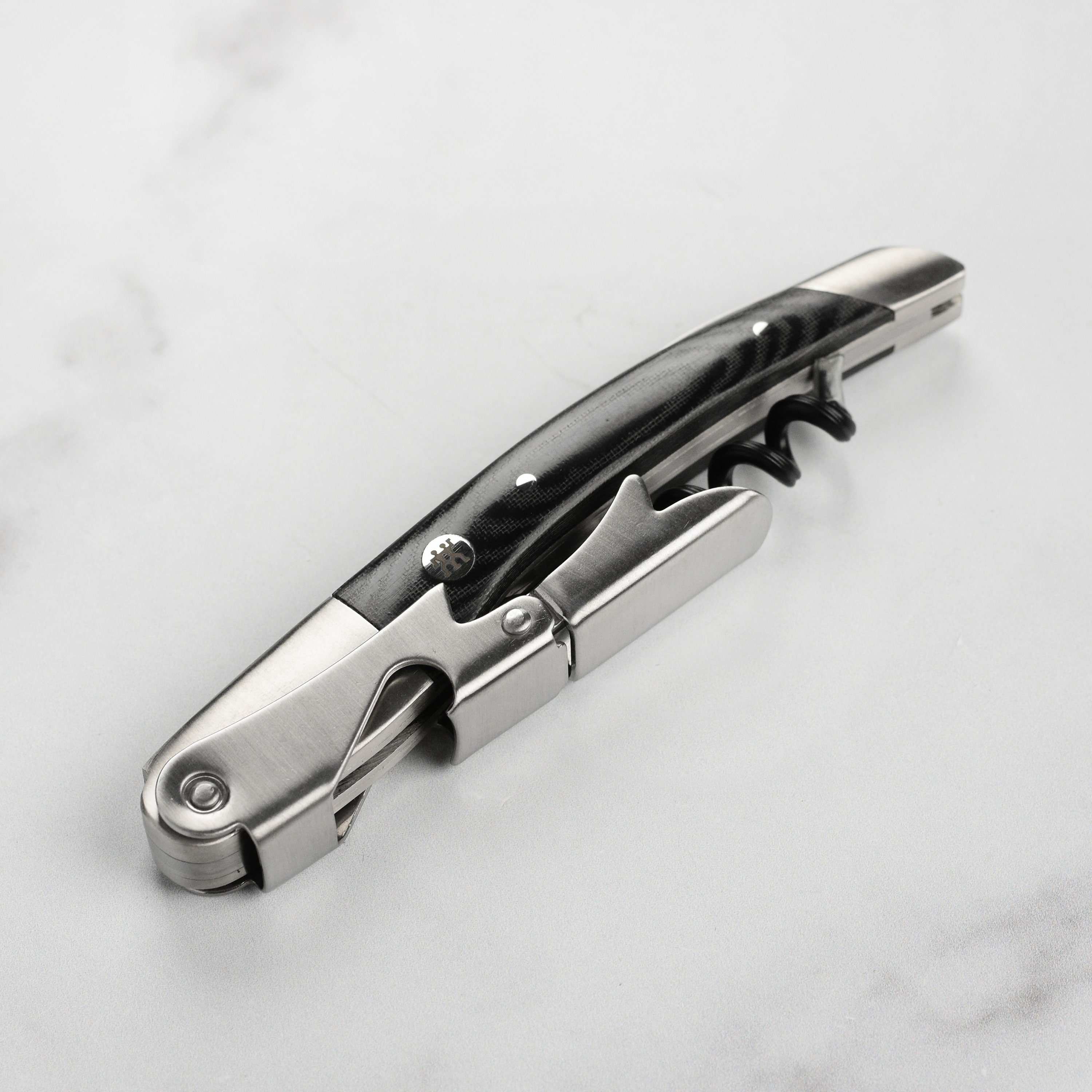 Close-up of the Micarta handle and stainless steel worm on a waiter's corkscrew