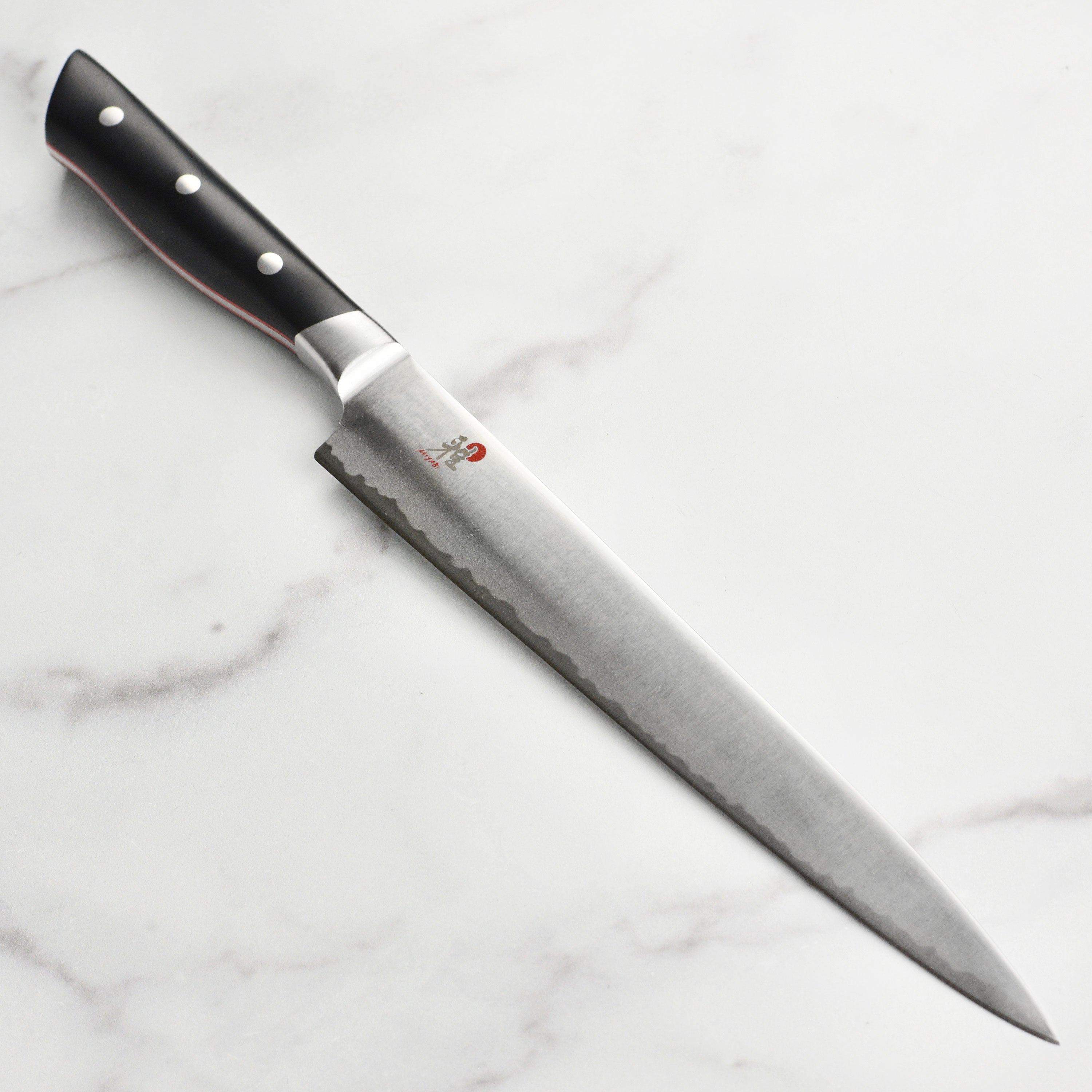Miyabi Evolution slicing knife showcasing the ergonomic handle and fine carbide steel blade.