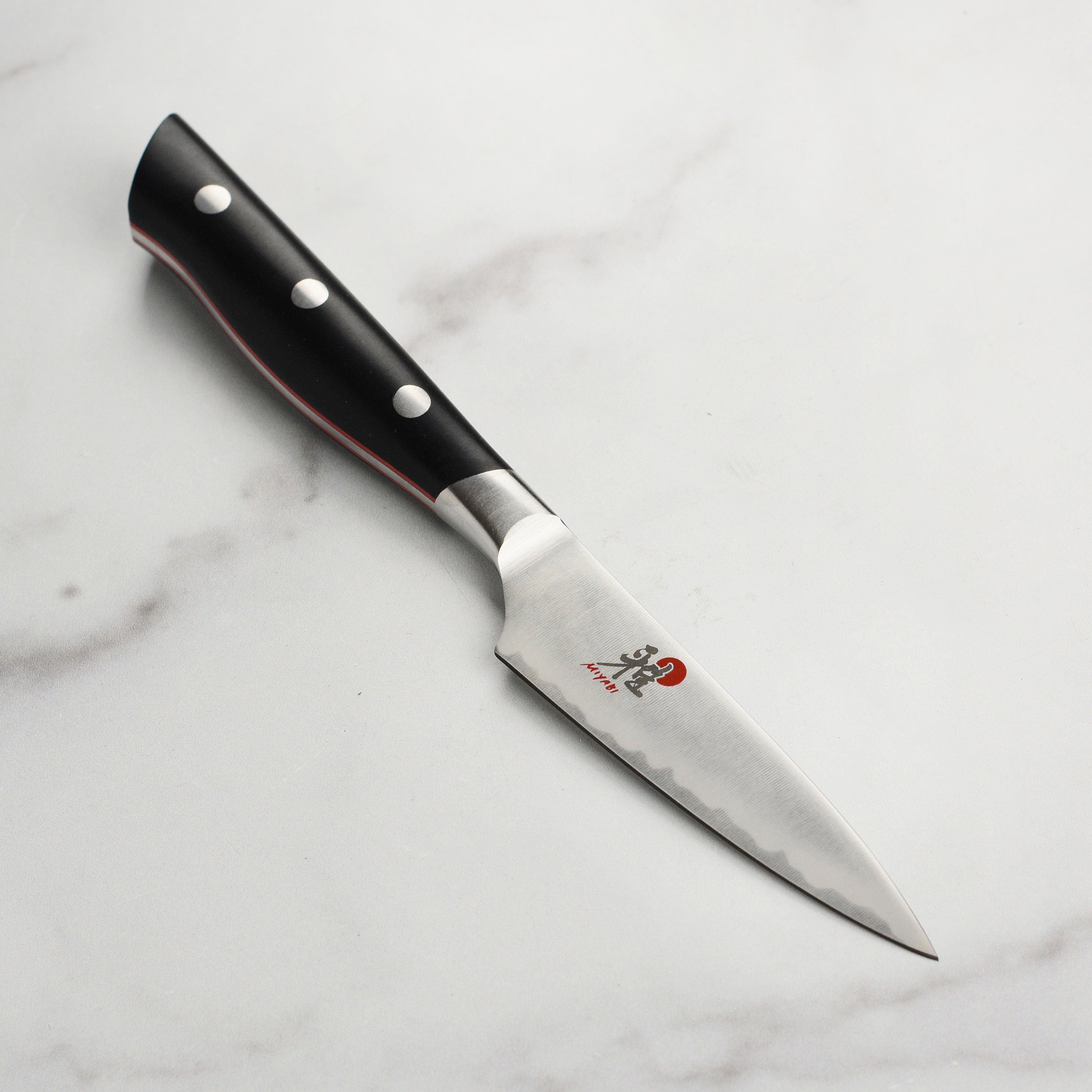 Miyabi Evolution 3.5-inch paring knife with a sharp edge, perfect for precision cutting in the kitchen.
