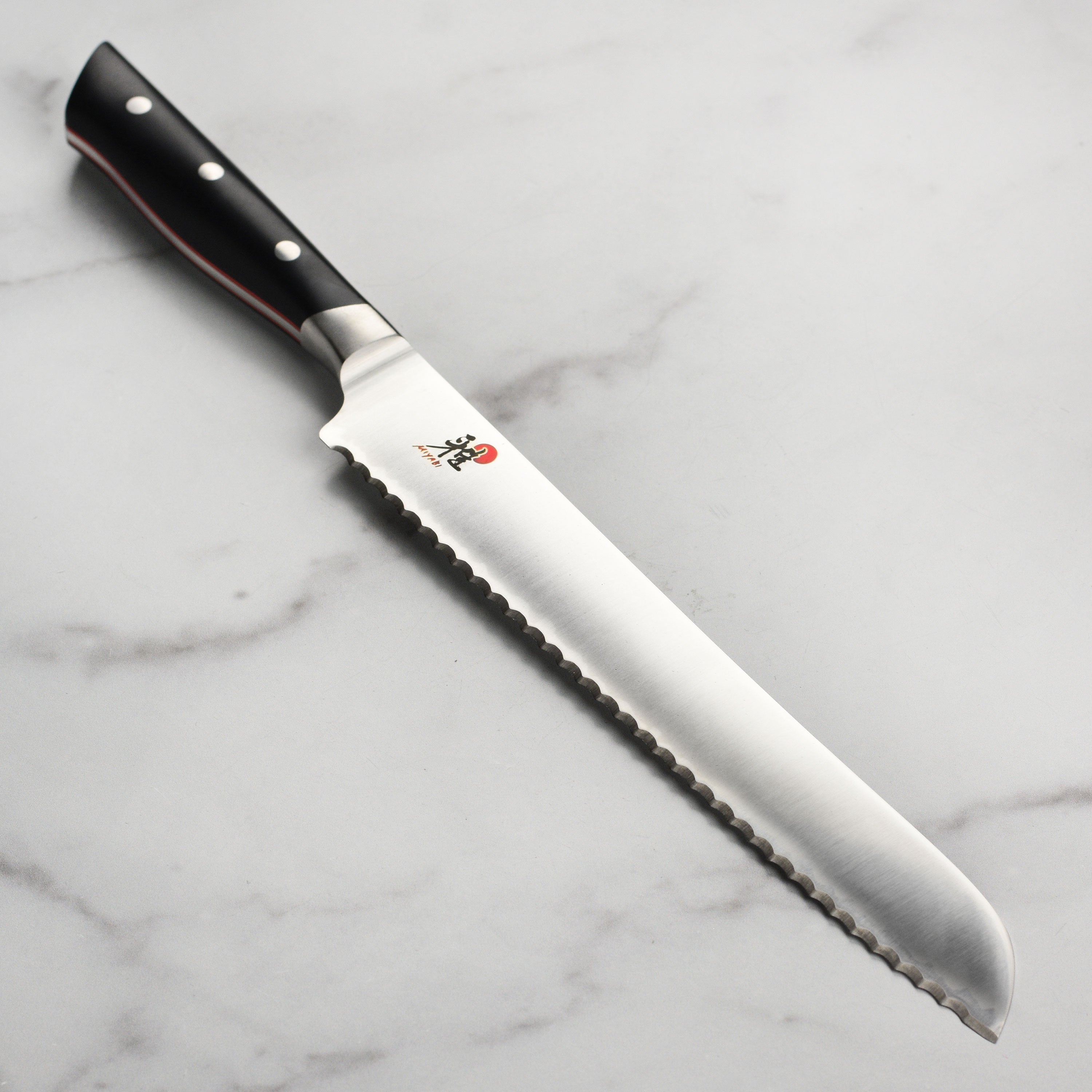 Miyabi Evolution 9-Inch Professional Bread Knife with a focus on the sharp blade and ergonomic handle.