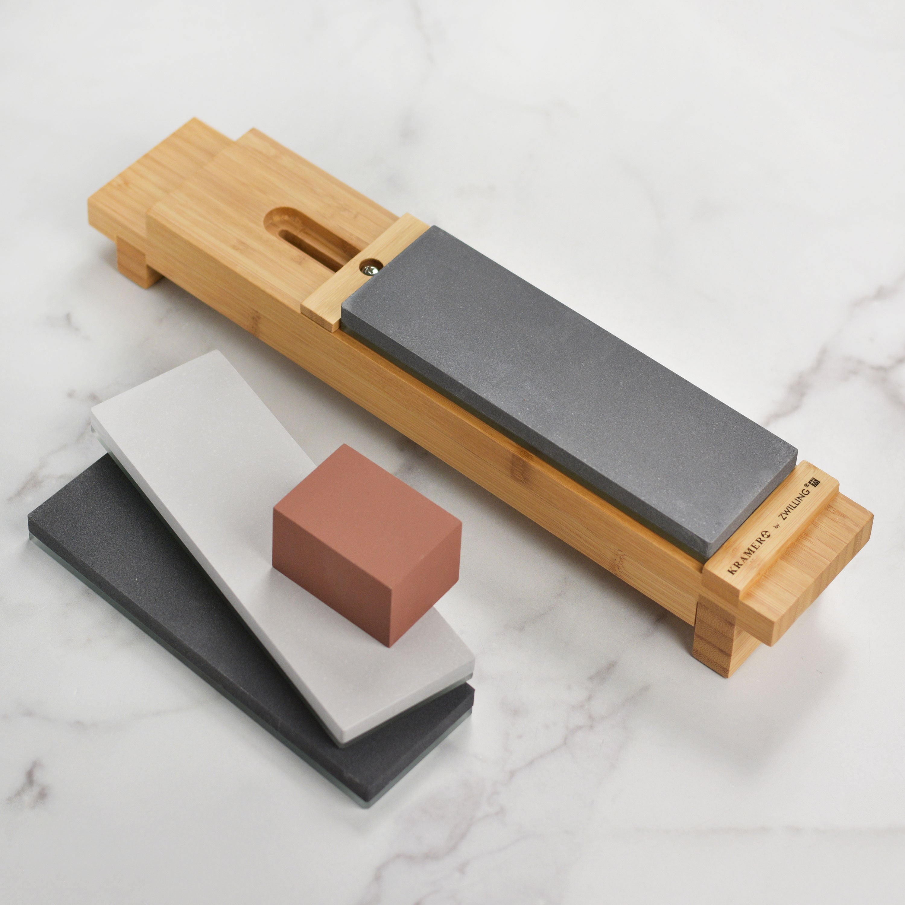 Close-up of Kramer ceramic whetstones showcasing #400, #1000, and #5000 grit textures.