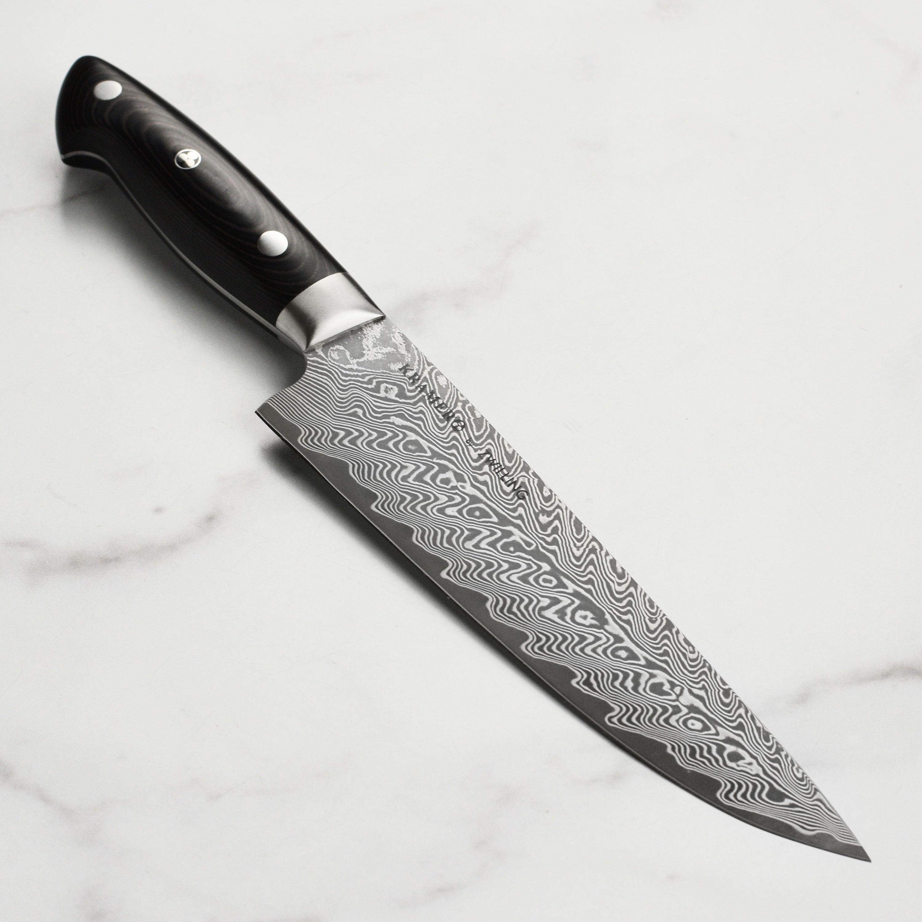 Close-up of Kramer Elite 8-Inch Damascus Chef's Knife blade highlighting the intricate Damascus pattern.