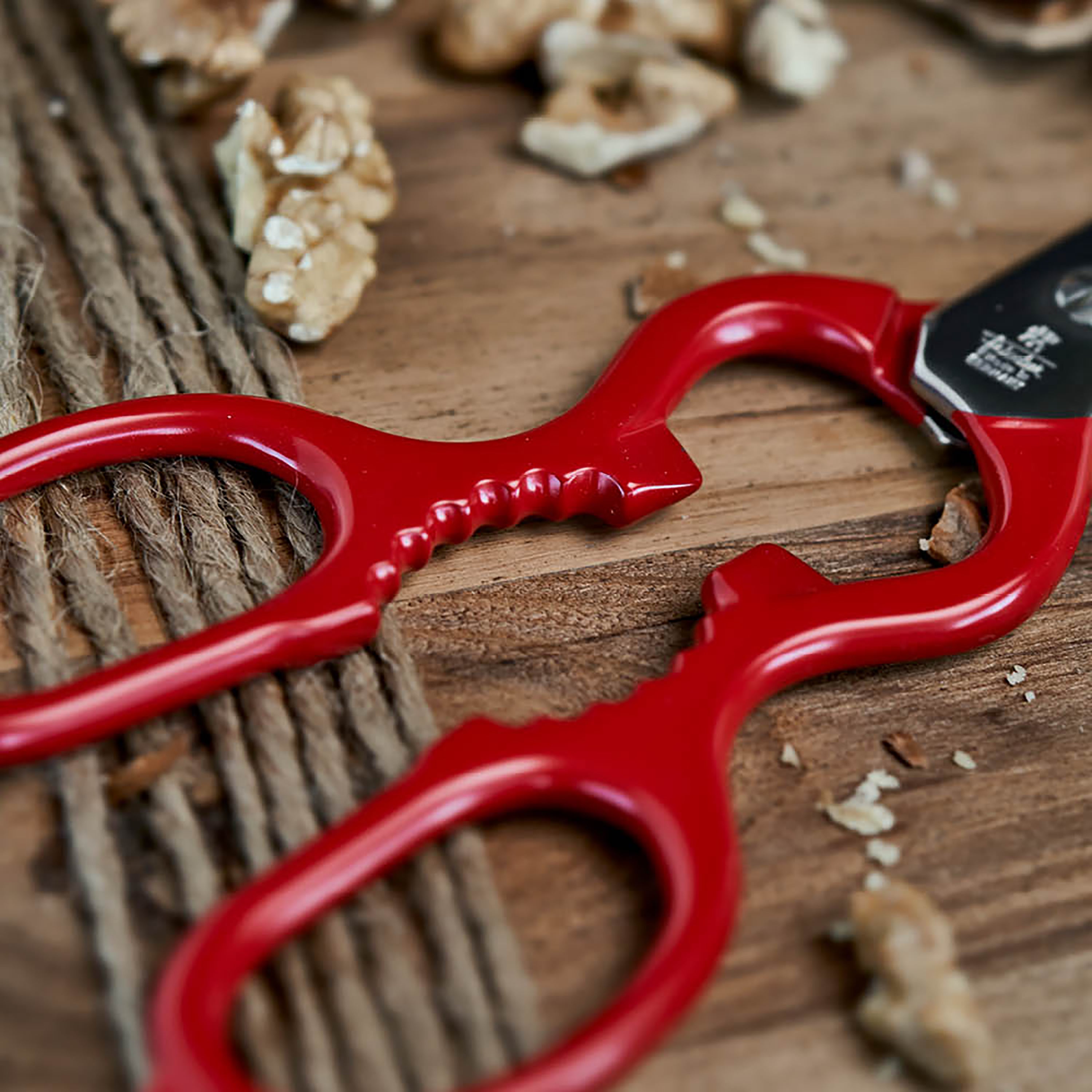 Red-coated handle of the kitchen shears featuring the integrated bottle opener.