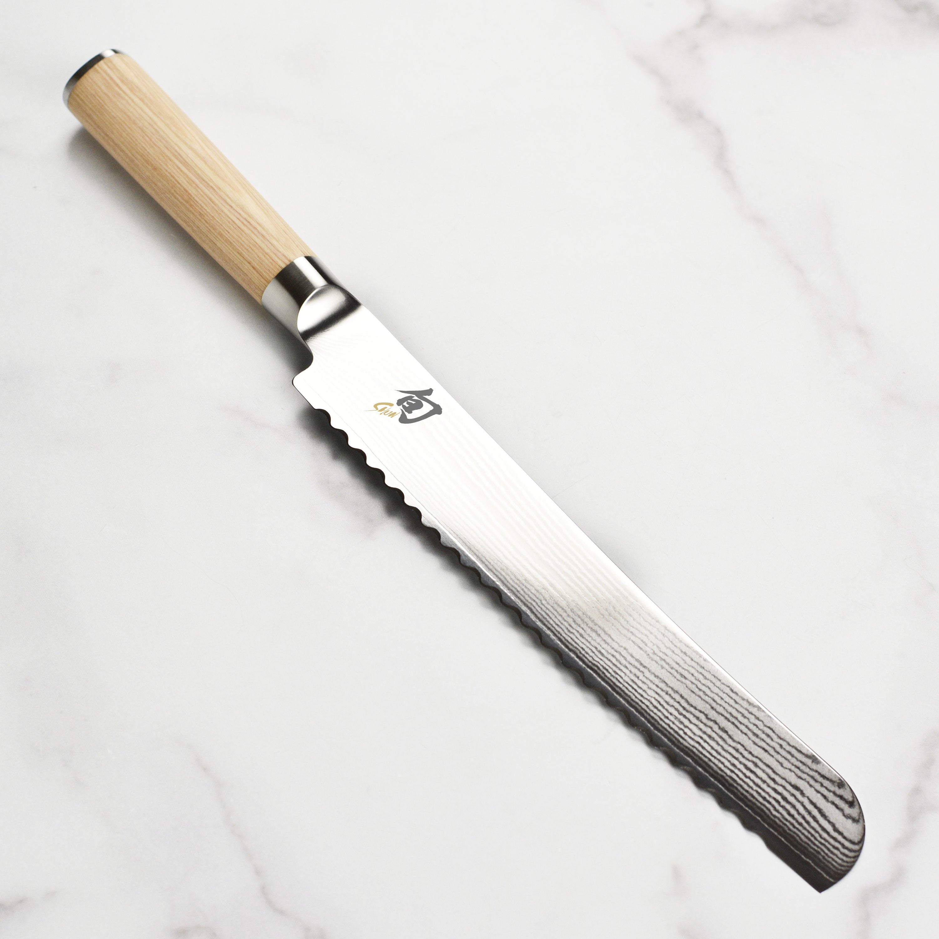 Shun Classic Blonde 9-Inch Bread Knife from the side, highlighting its blade and handle design.