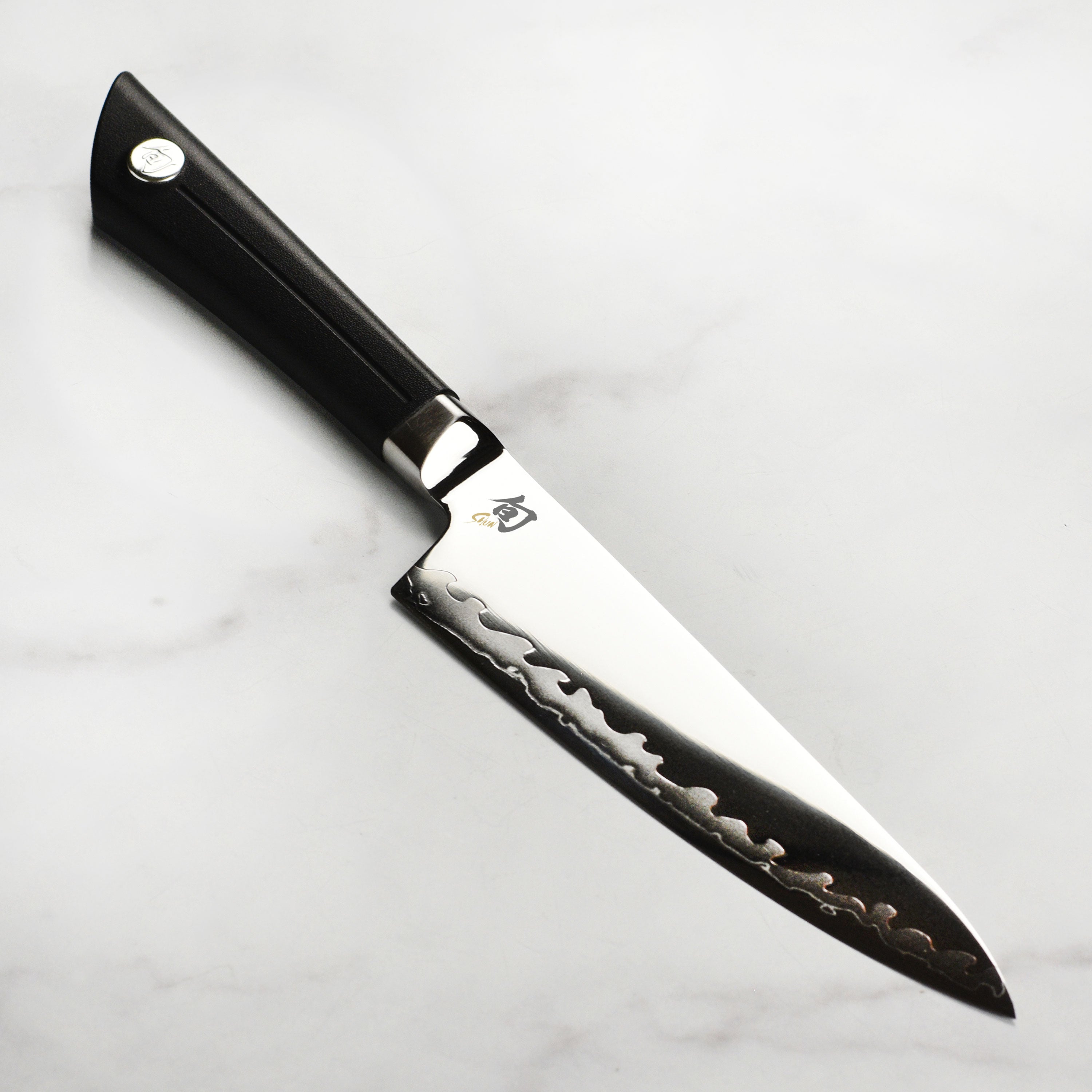Shun Sora 6-inch Japanese chef's knife blade with hamon pattern and textured handle