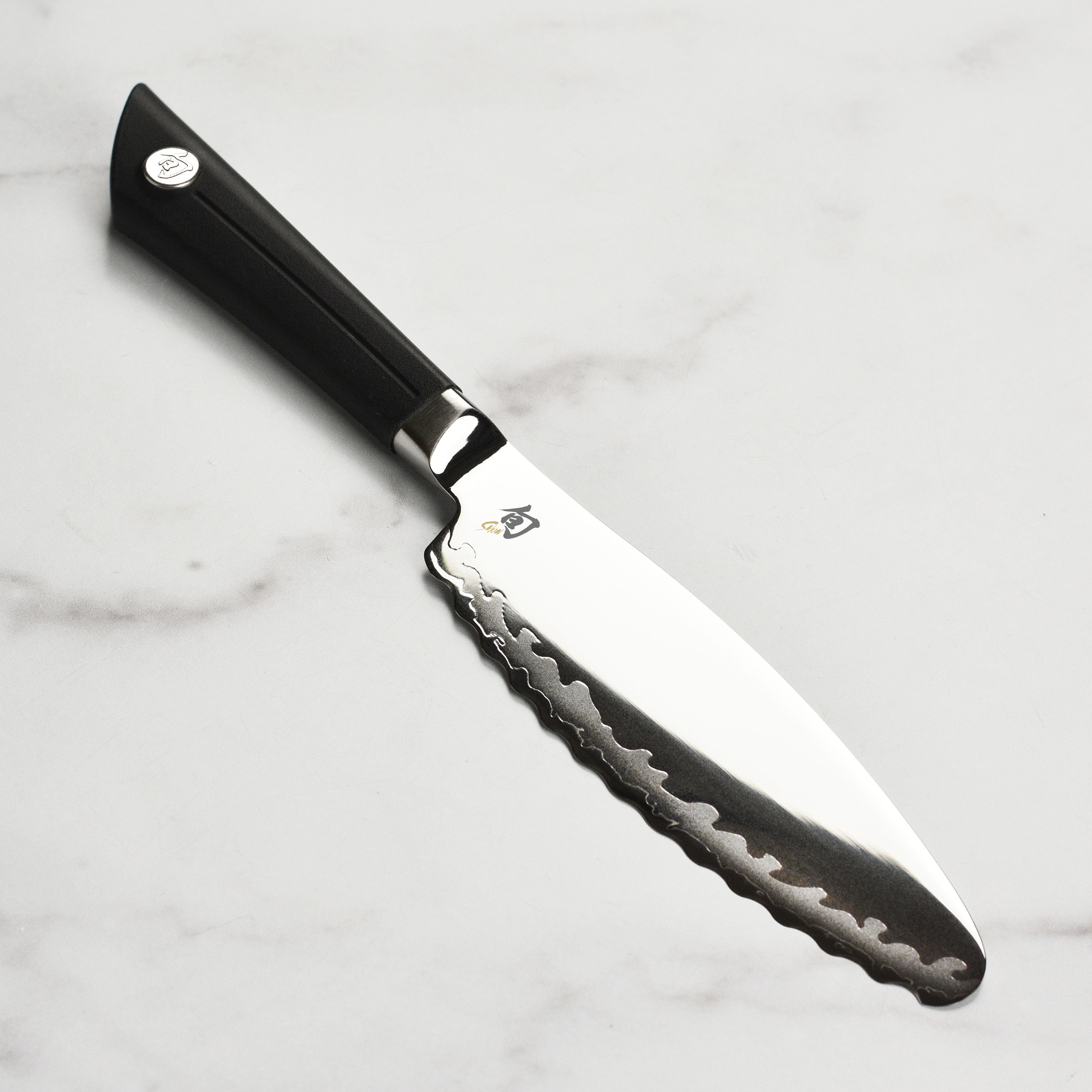 Close-up of the Shun Sora utility knife showcasing its VG10 blade and unique design.