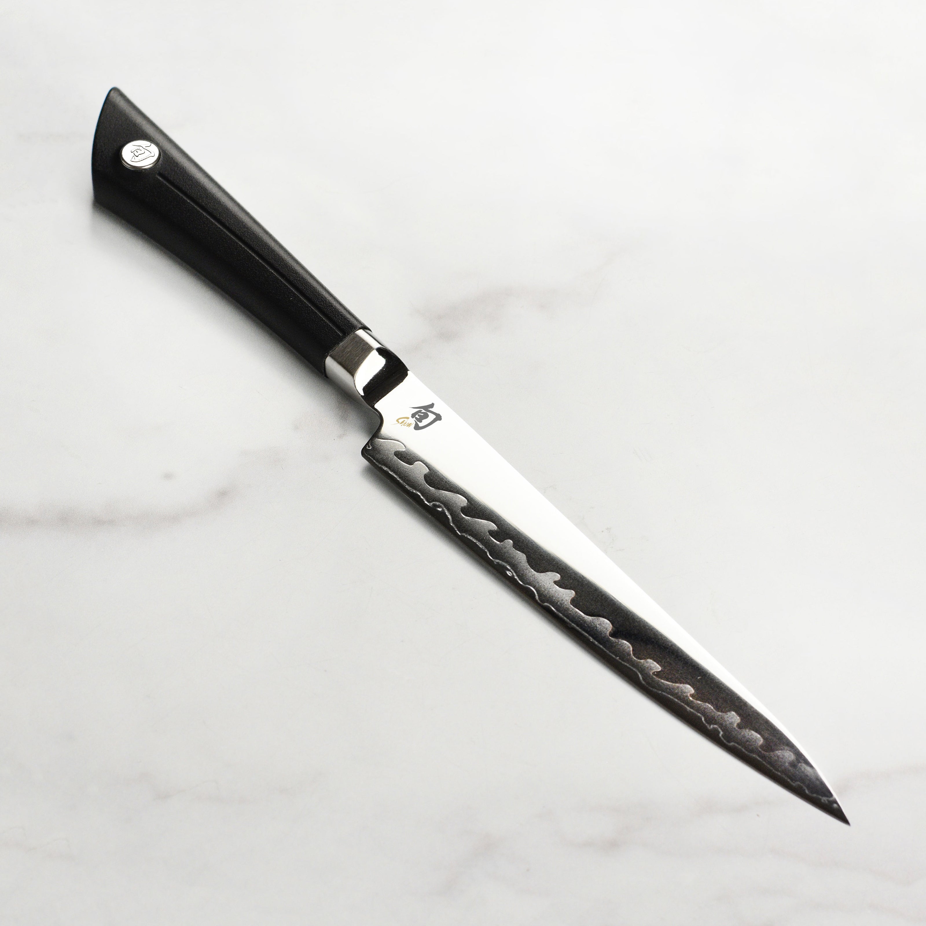 Close-up of Shun Sora 6-Inch Utility Knife blade highlighting the precision edge and craftsmanship.