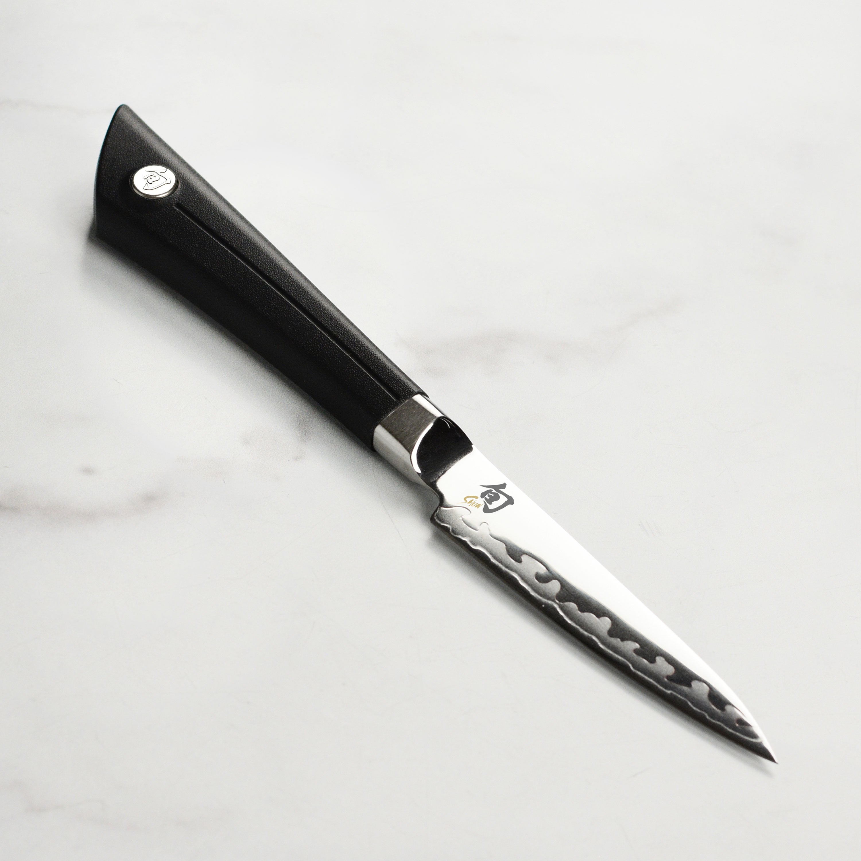 Close-up of the Shun Sora paring knife blade, highlighting its sharp edge and craftsmanship.