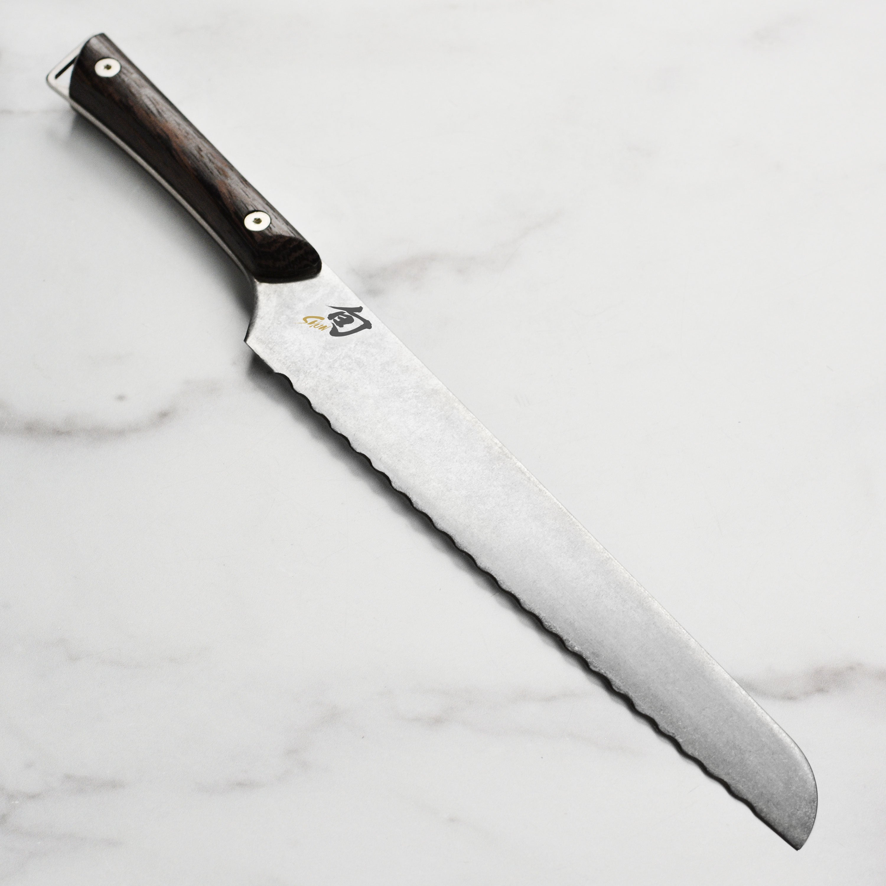 Shun Kanso 9-inch Japanese bread knife blade close-up, showcasing its sharp edge and heritage finish