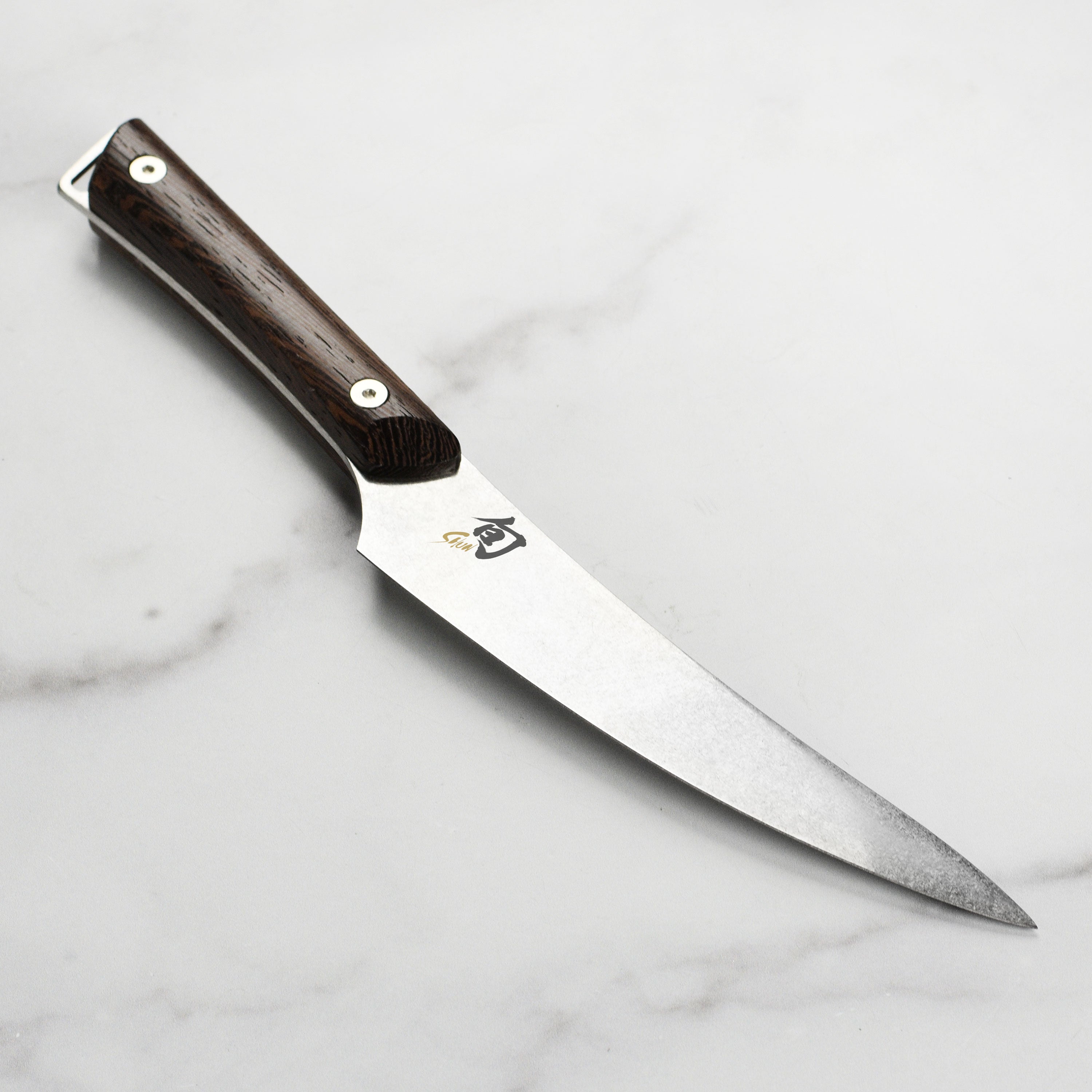 Close-up of Shun Kanso fillet knife showing the heritage finish and wood handle