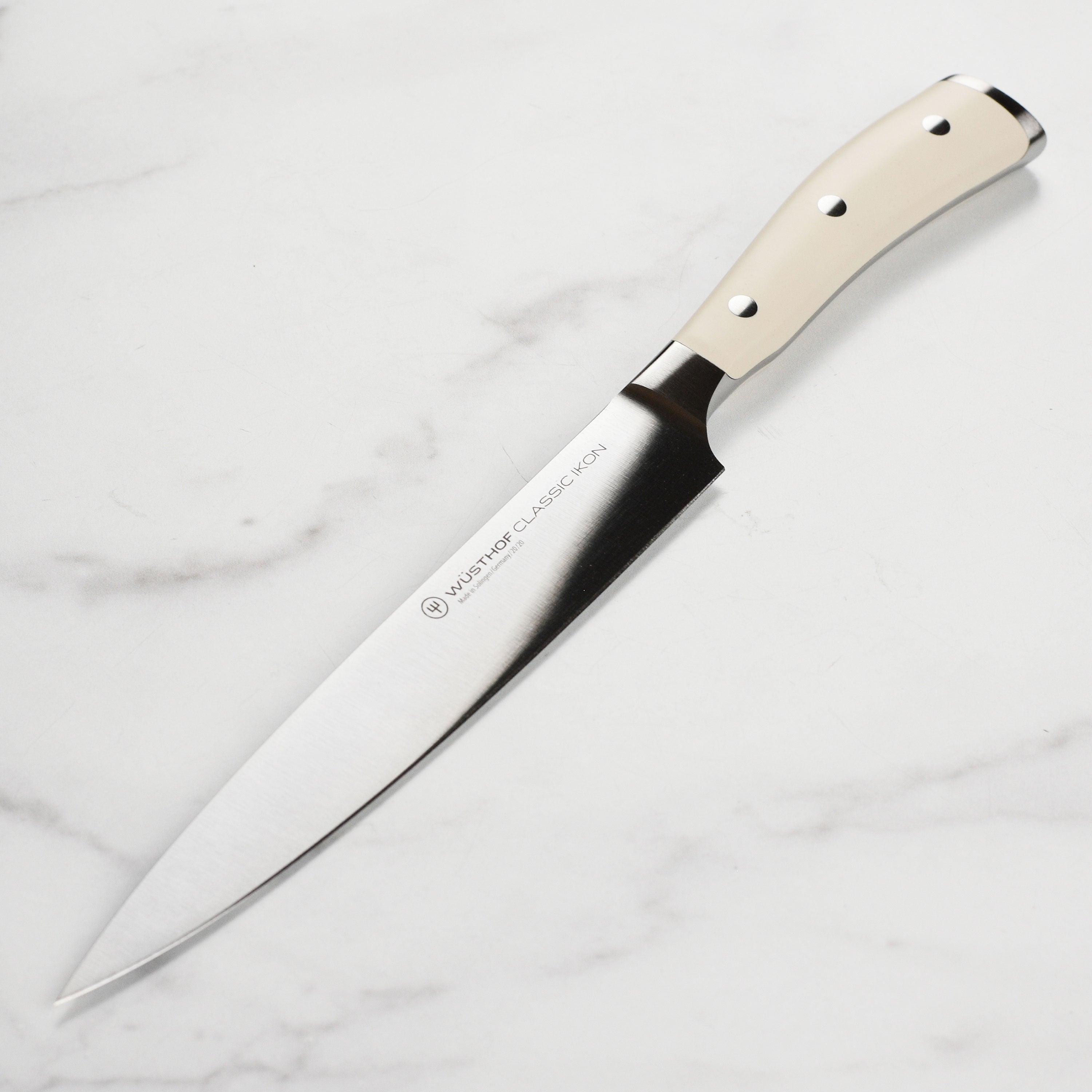 Wüsthof Classic Ikon Creme 8-inch carving knife blade close-up, highlighting sharpness and quality steel