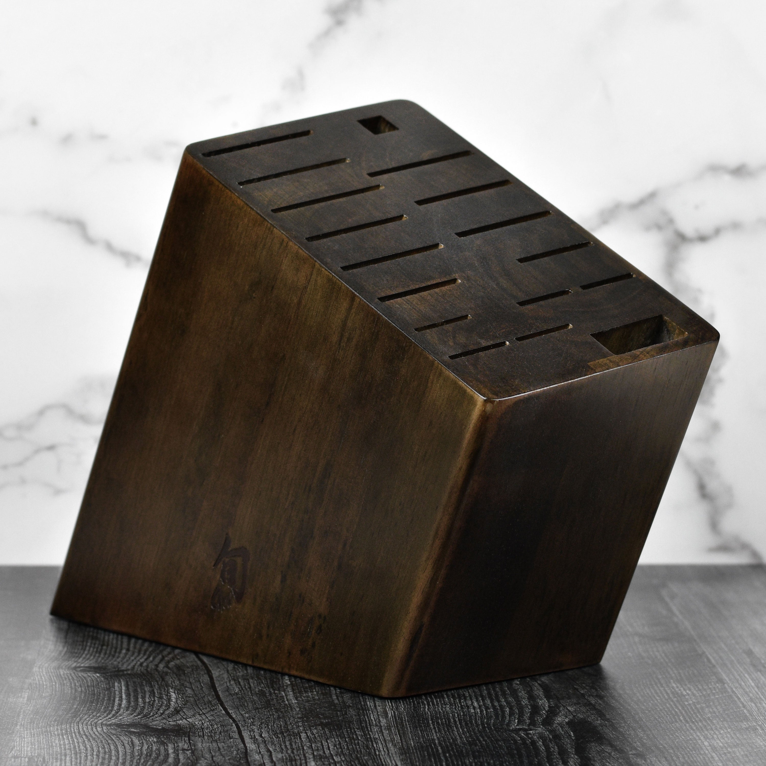 Angled view of the walnut knife holder showcasing its 17 slots for kitchen cutlery.
