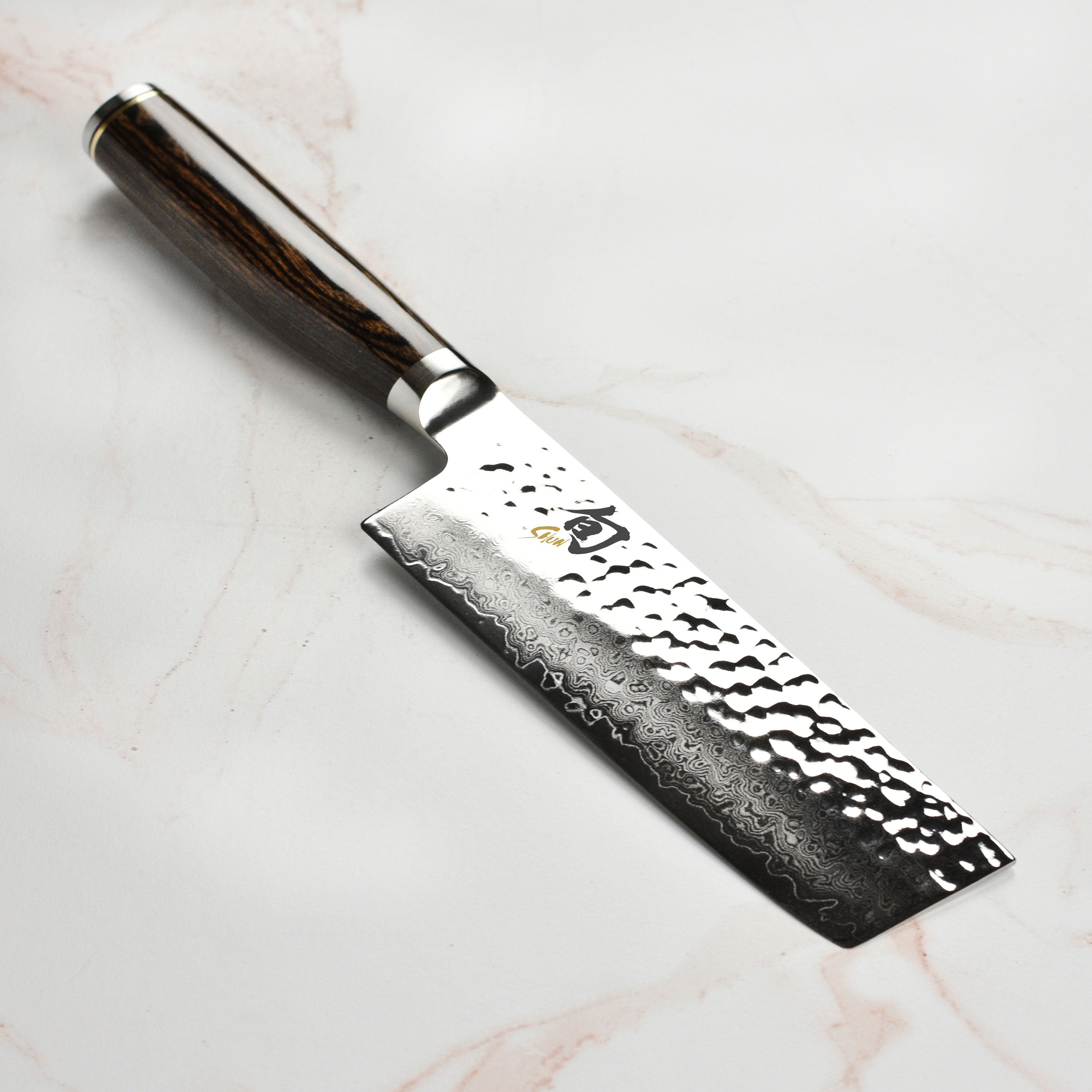 Japanese Nakiri knife with Damascus layered blade in a kitchen setting