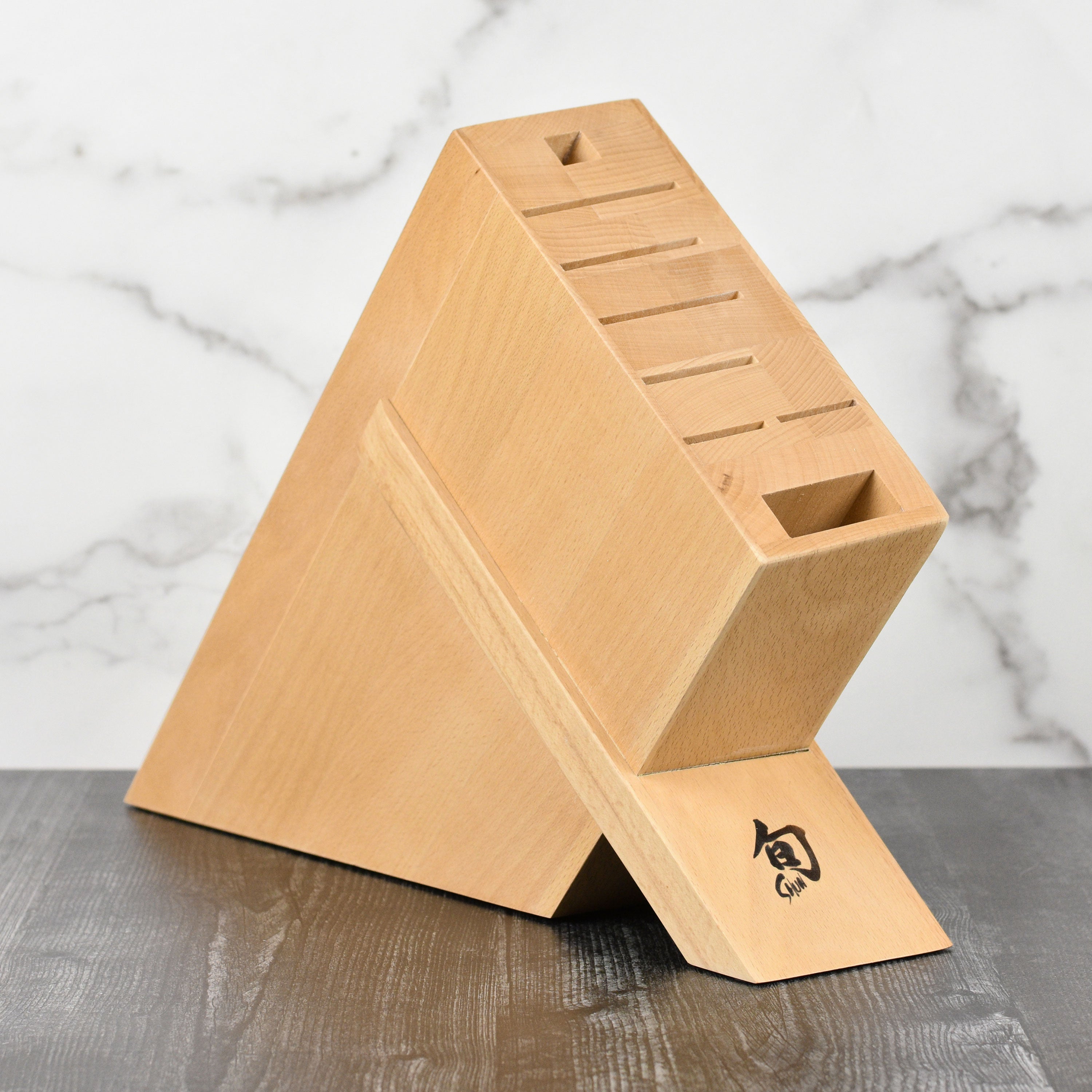Elegant beechwood knife block showcasing its angled design and spacious slots for cutlery.