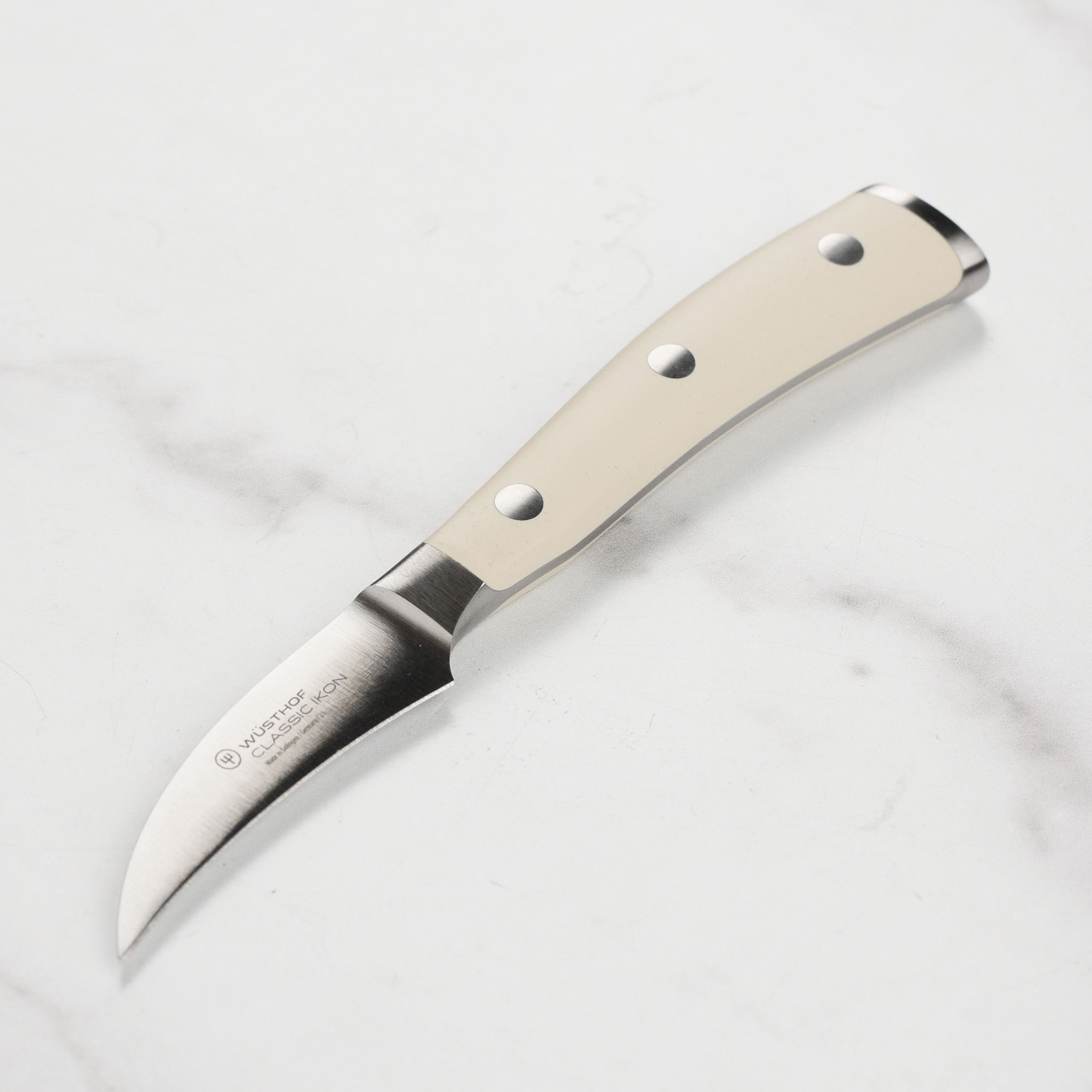 High-resolution image of a premium stainless steel peeling knife showing the blade and handle for detailed peeling tasks