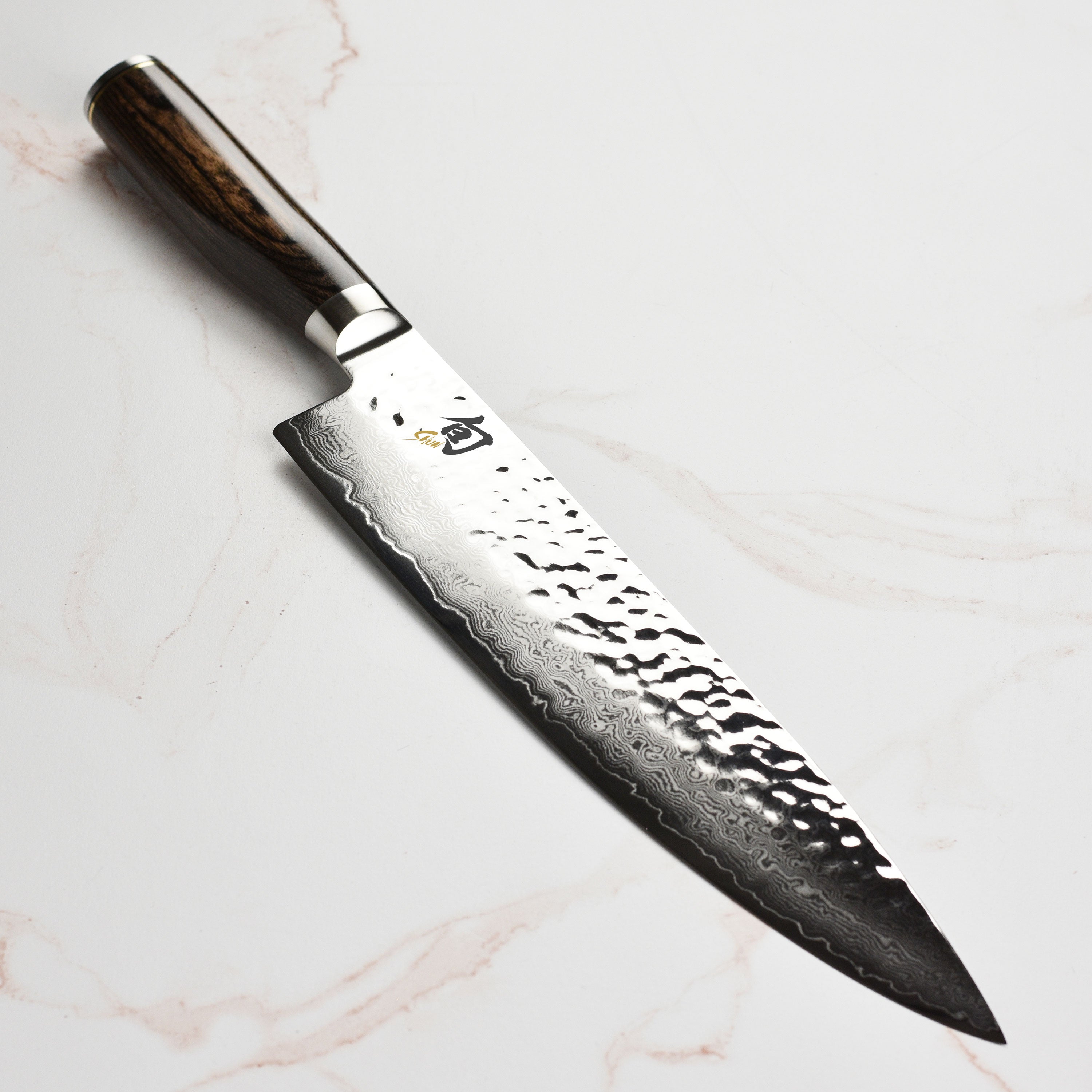 Shun Premier 10-inch Japanese chef's knife with Damascus layered blade and walnut handle for professional kitchens