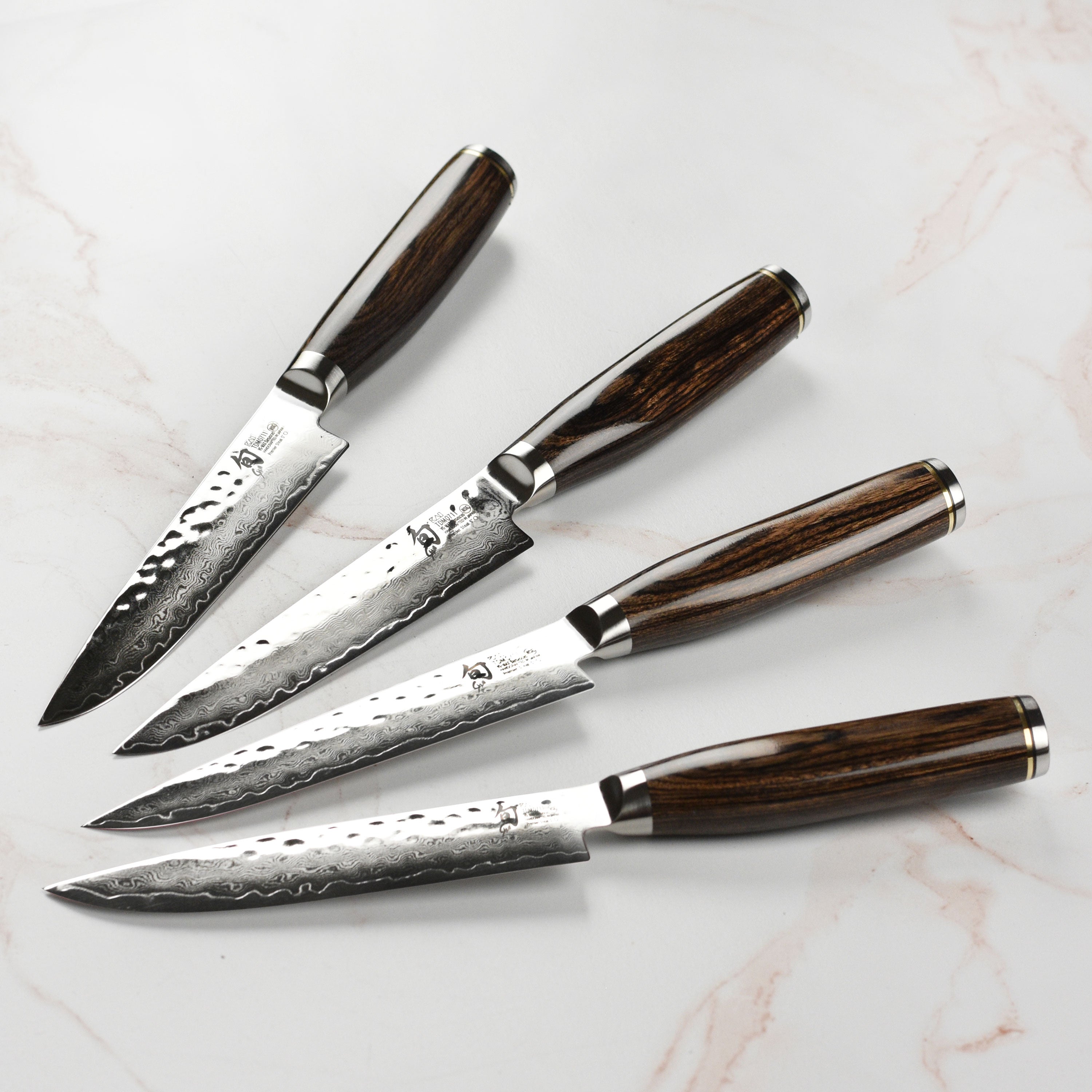 Close-up view of Shun Premier steak knives showing Damascus layering and hammered finish – premium cutlery craftsmanship